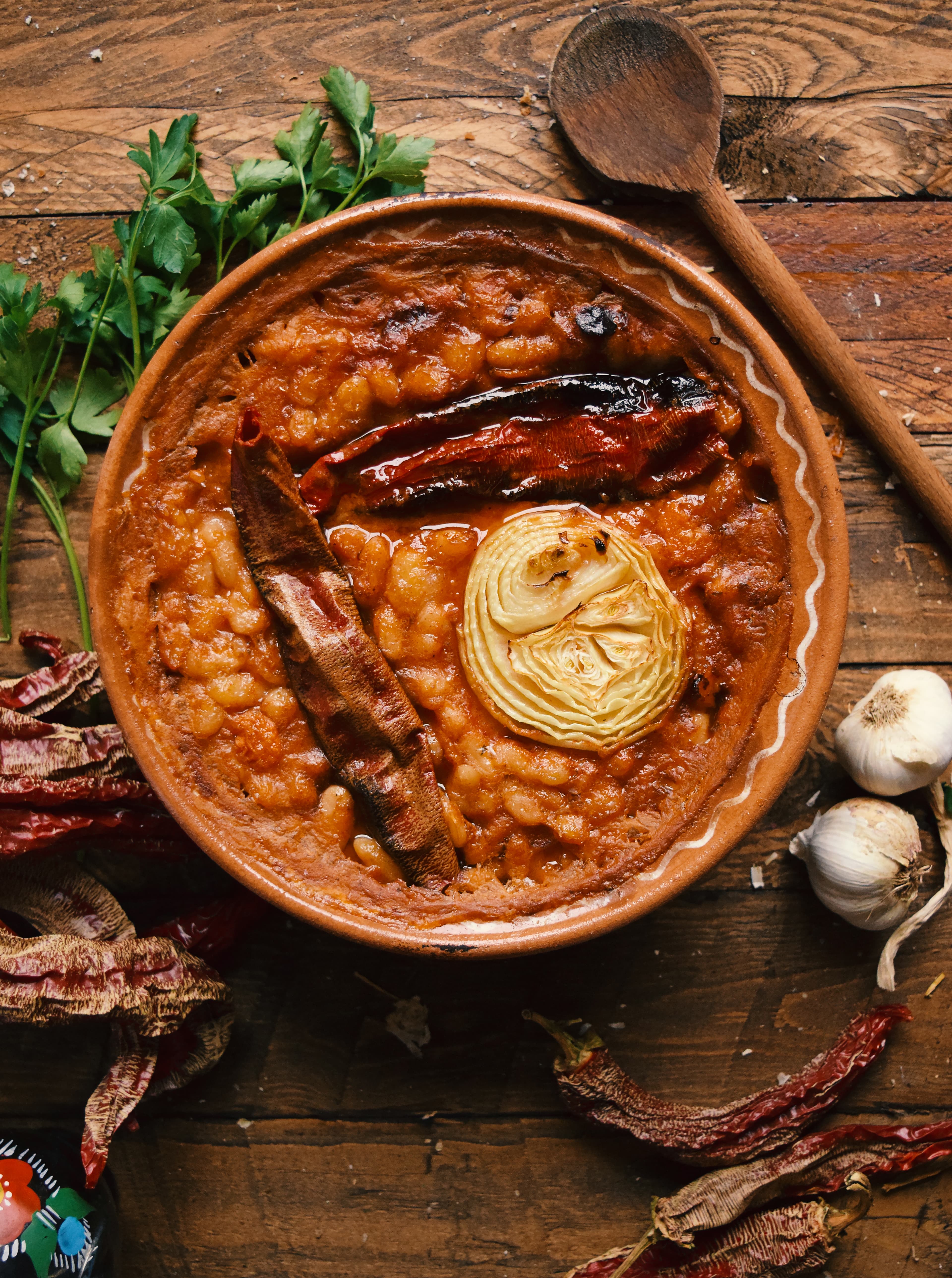 Tavče gravče — a north macedonia cuisine main course dish from North Macedonia — featuring baked, earthenware vessel, fresh beans