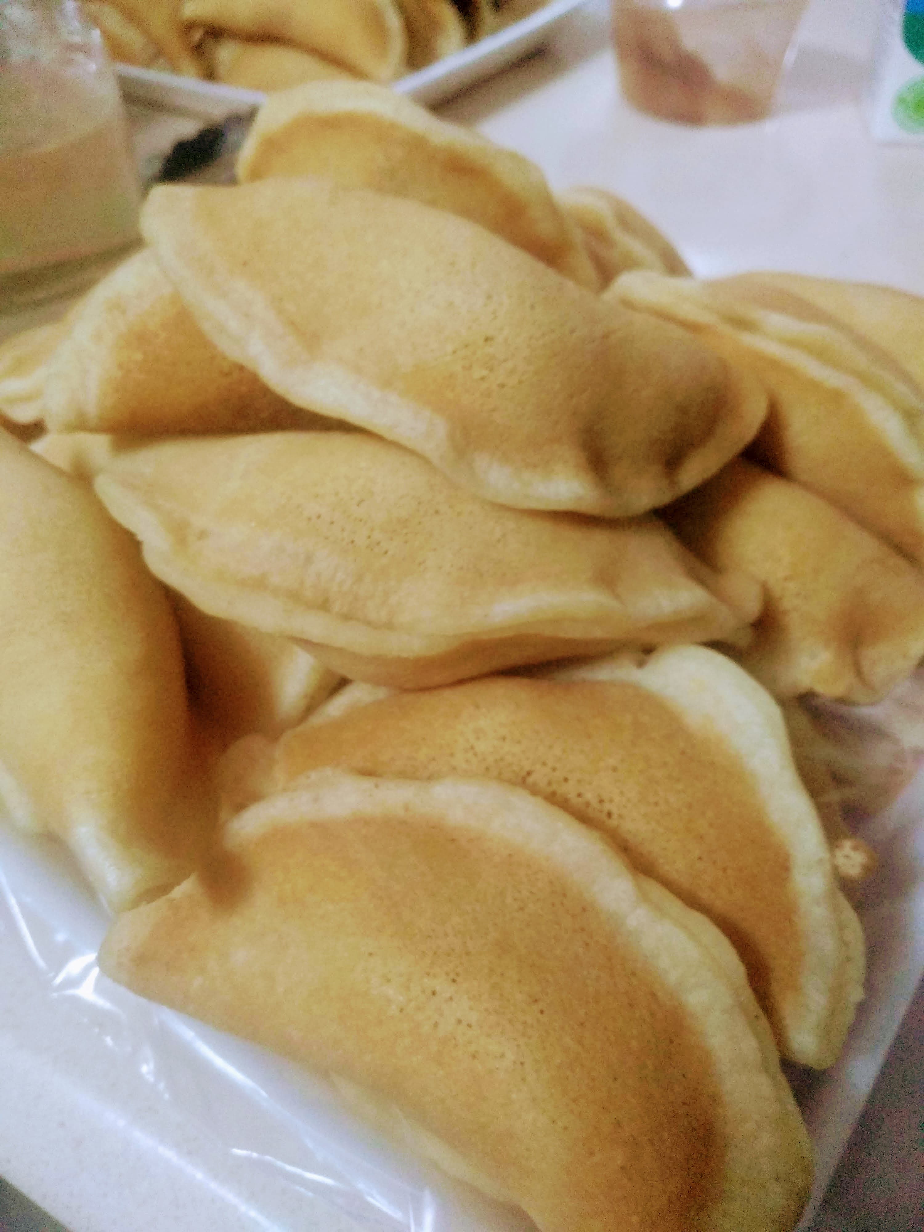 Qatayef — a levant cuisine dessert dish from Levant — featuring folded dumpling, one-sided pancake, cream & nut filled