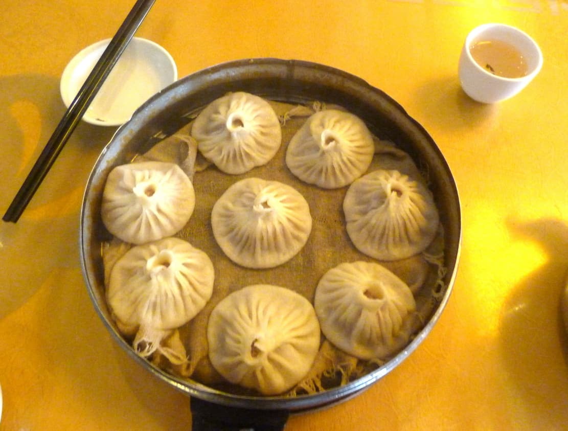 Tangbao — a people's republic of china cuisine main course dish from People's Republic of China — featuring gelatinous filling, steamed wrapper, soup-filled