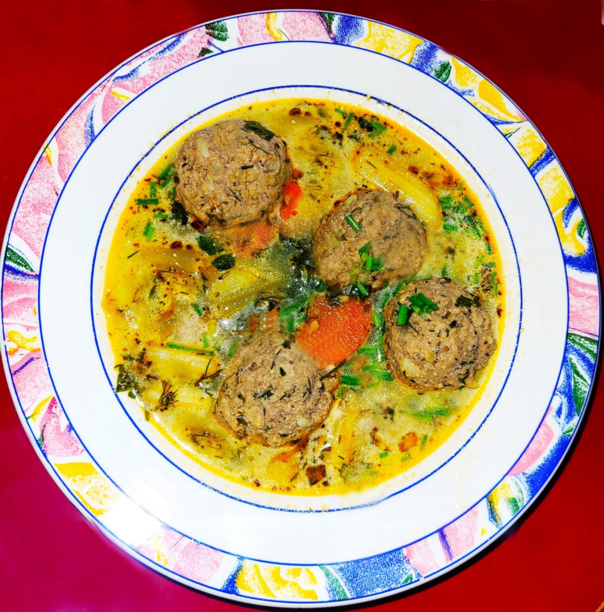 Ciorbă de perișoare — a romanian main course dish from Romania — featuring sour broth, pork meatballs, vegetable-forward