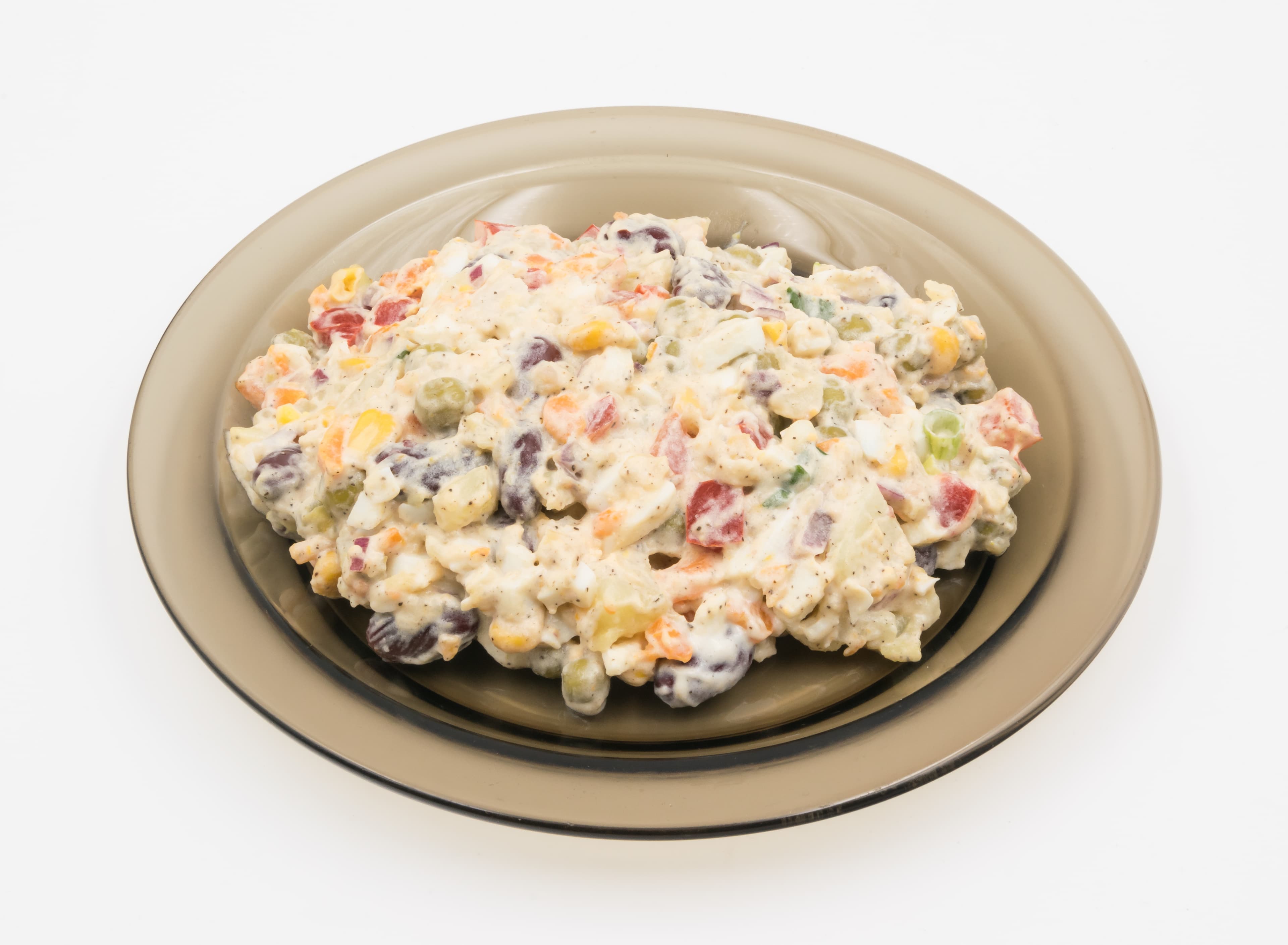 Olivier salad — a russian main course dish from Russia — featuring mayonnaise-bound, diced vegetables, pickled brined notes