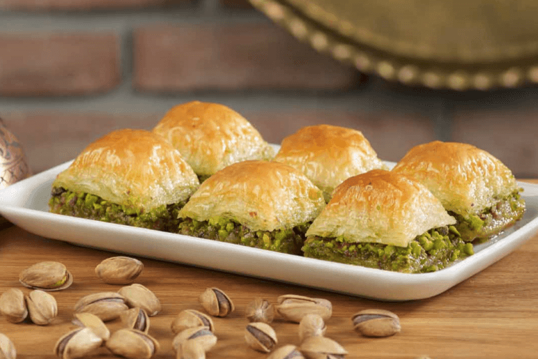 Baklava — a ottoman empire cuisine dessert dish from Ottoman Empire — featuring layered pastry, filo sheets, nut-filled