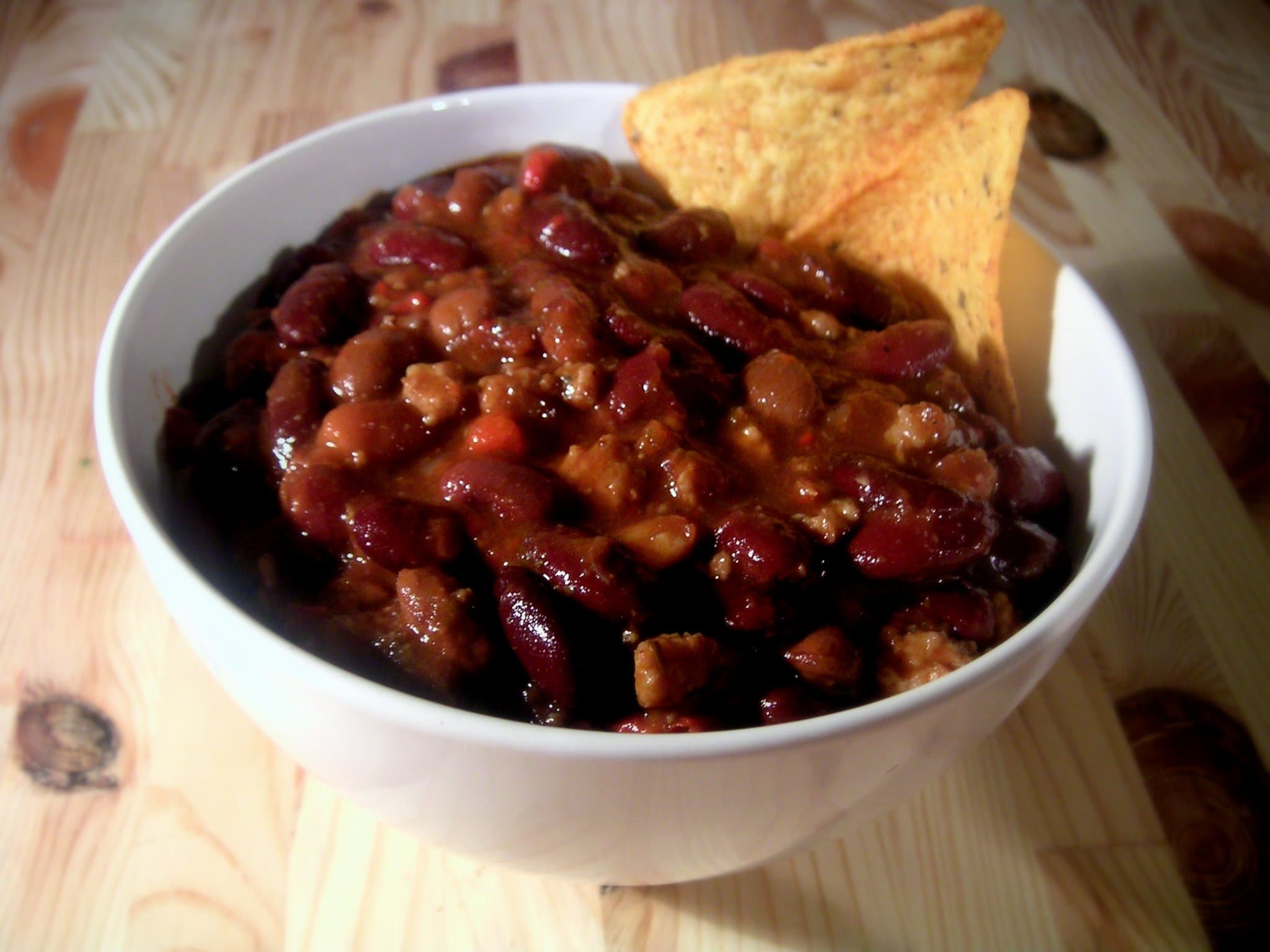 Chili con carne — a mexican main course dish from Mexico — featuring spiced beef stew, slow-simmered heat, tomato-forward