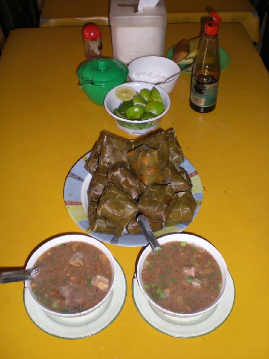 Coto makassar — a indonesian breakfast dish from Indonesia — featuring spiced peanut broth, beef & organ meat, fermented soy paste