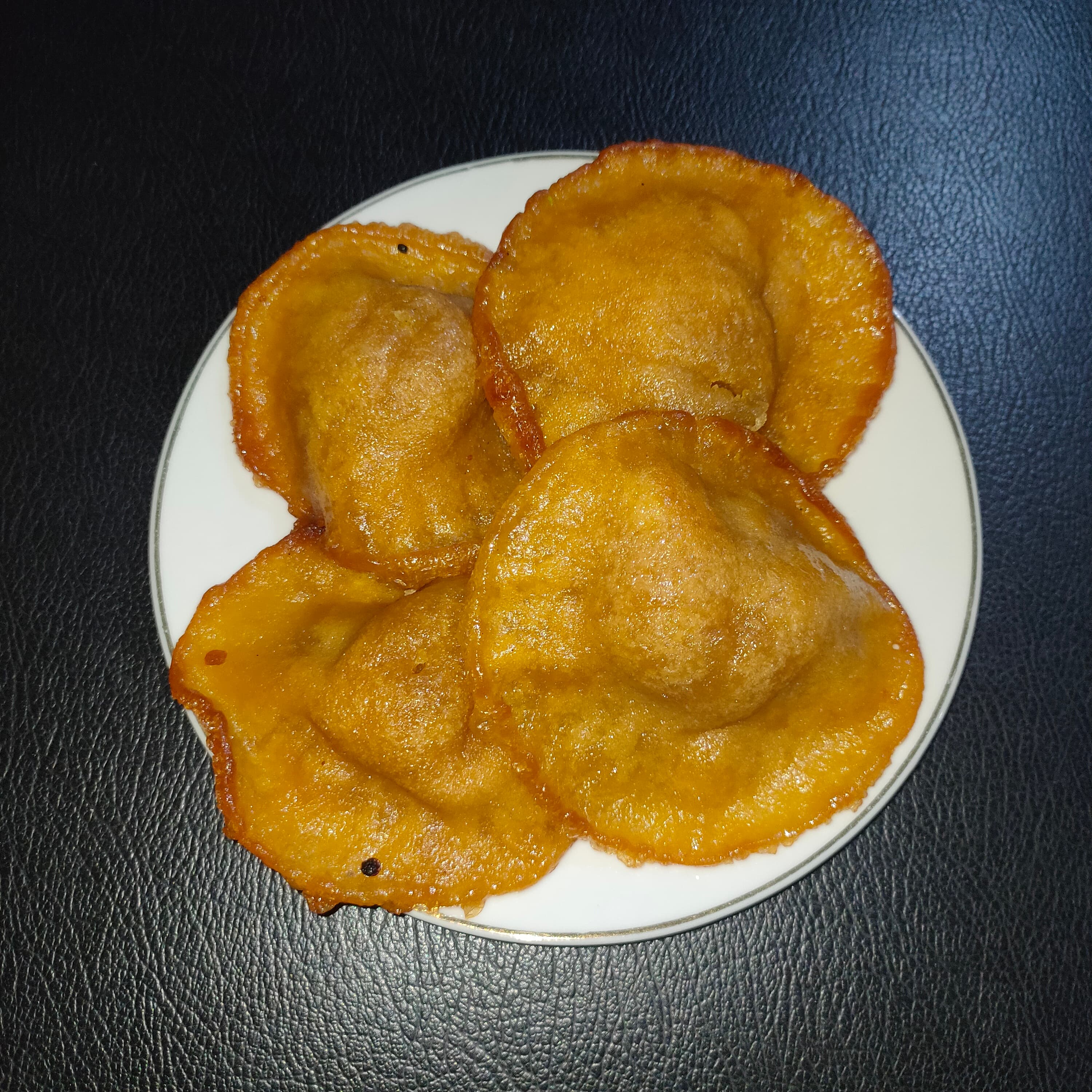 Kue cucur — a indonesian dessert dish from Indonesia — featuring fried fritter, rice flour base, palm sugar sweetened