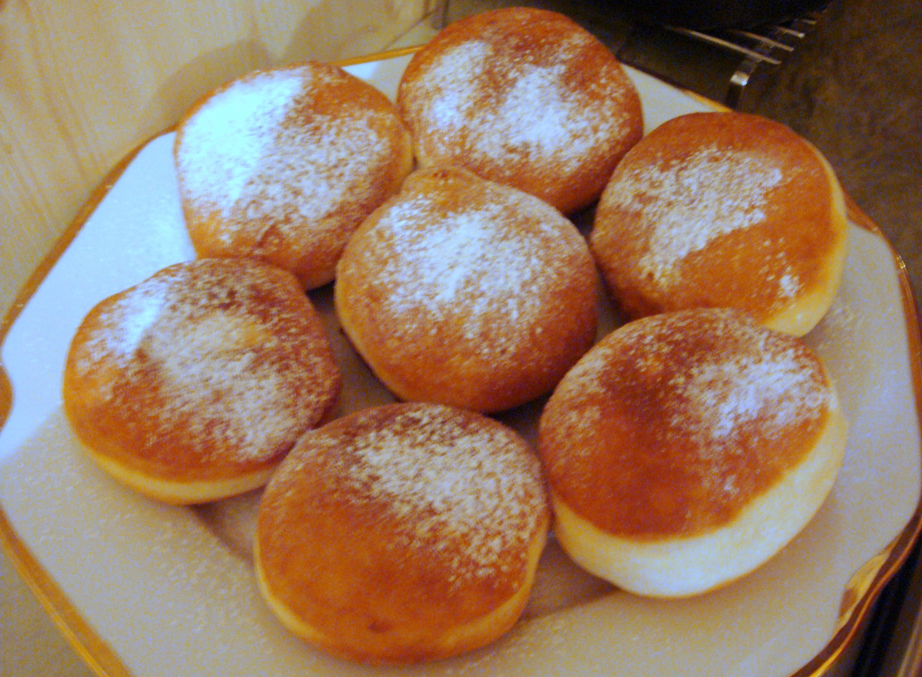 Gogoși — a romanian main course dish from Romania — featuring deep-fried, fluffy interior, filled doughnuts