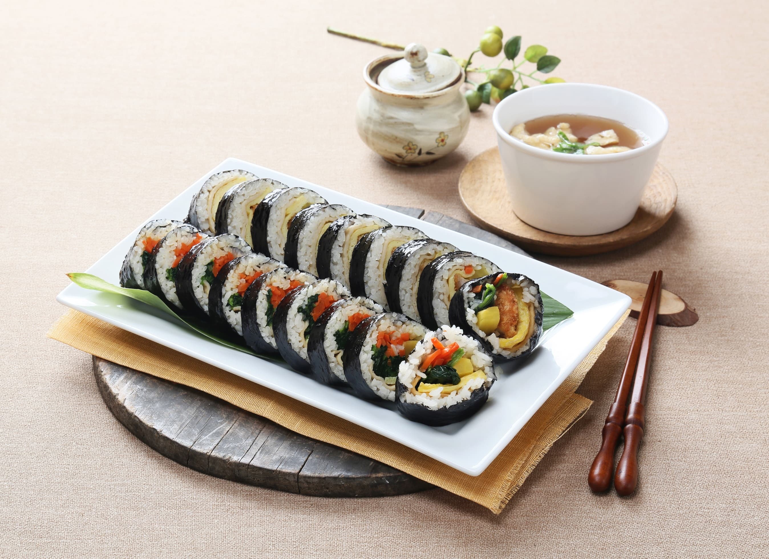 Gimbap — a korea cuisine main course dish from Korea — featuring rolled and sliced, seaweed-wrapped, portable