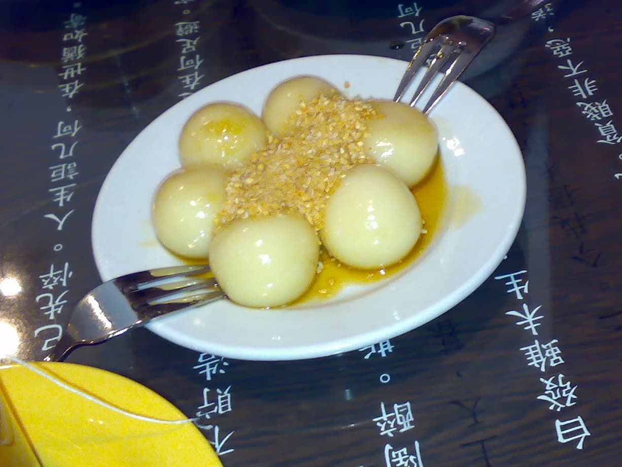 Tang bu shuai — a people's republic of china cuisine dessert dish from People's Republic of China — featuring glutinous rice, sugar syrup, sticky binding