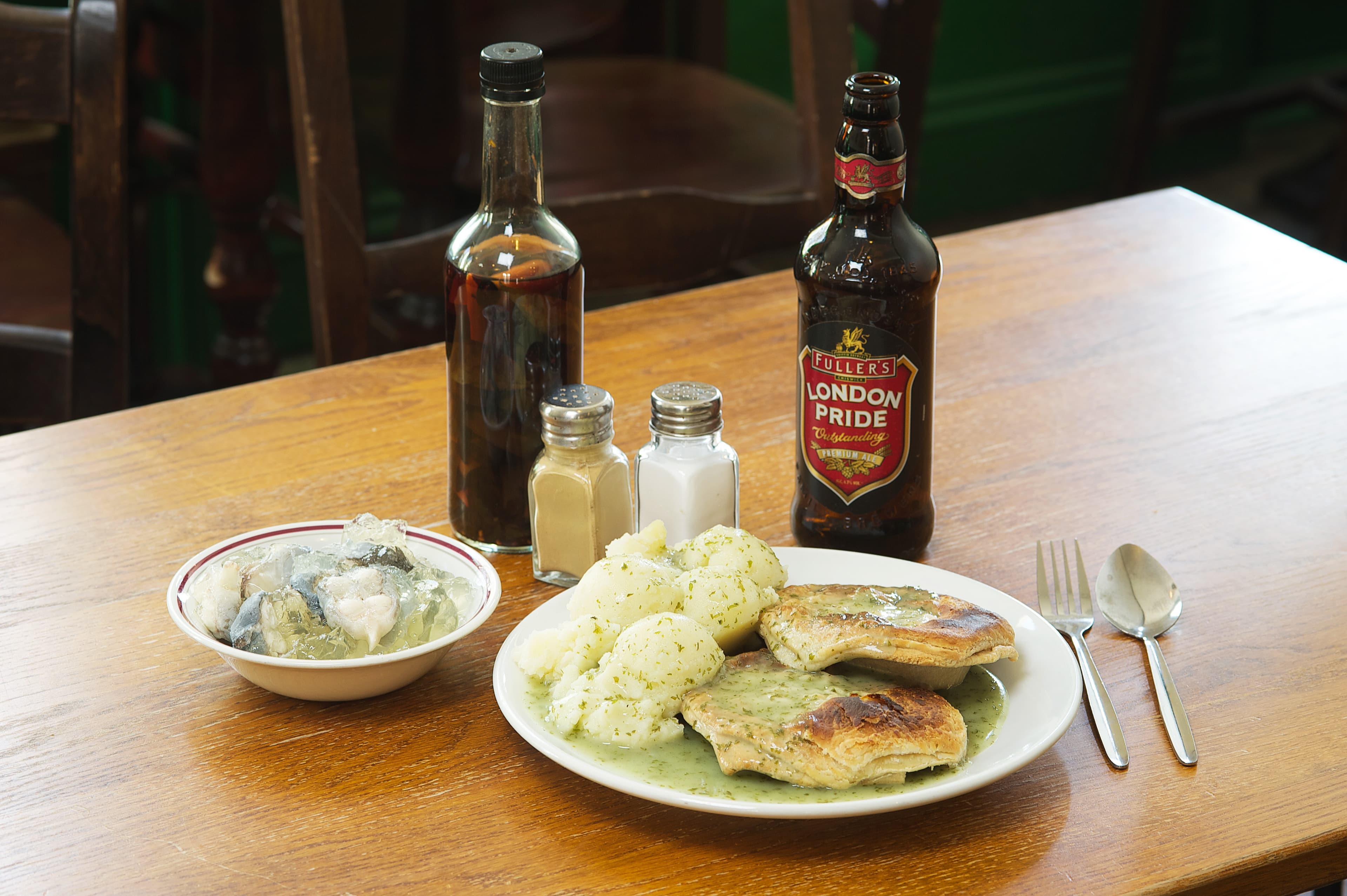 Pie and mash — a british main course dish from United Kingdom — featuring working-class, minced beef pie, parsley liquor
