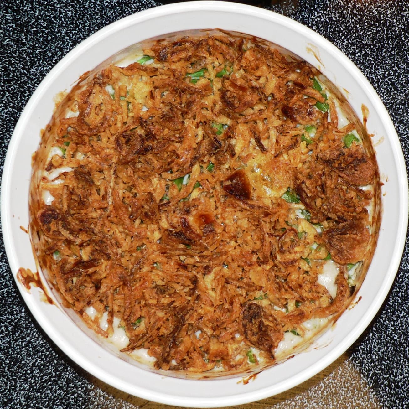 Green bean casserole — a american main course dish from United States — featuring creamy base, crispy topping contrast, can-soup ancestry
