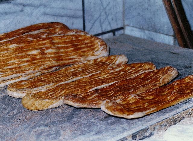 Barbari bread — a iranian main course dish from Iran — featuring yeast-leavened, thick flatbread, Maillard-crusted