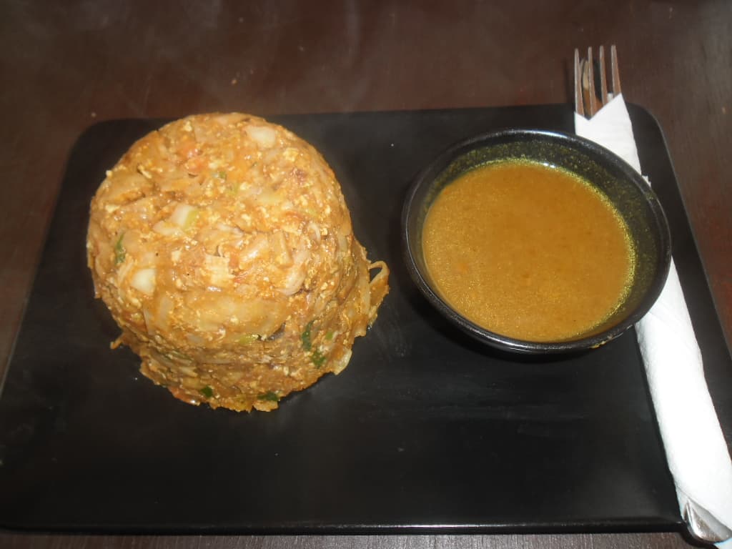 Kottu — a indian main course dish from India — featuring chopped & tossed, egg-scrambled, meat curry-based
