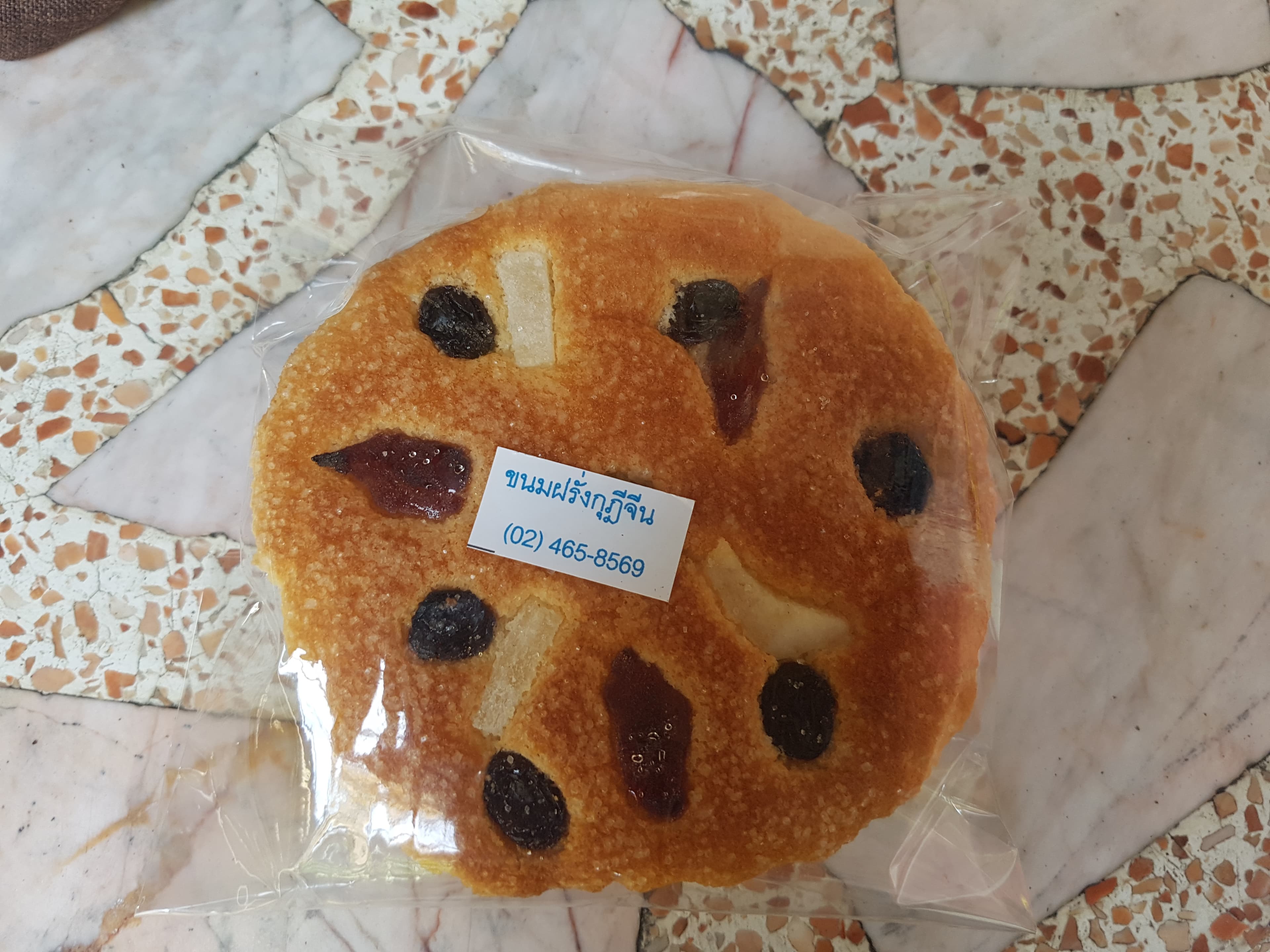Khanom farang kudi chin — a thai dessert dish from Thailand — featuring no-yeast cake, Portuguese-influenced, luck-symbol toppings