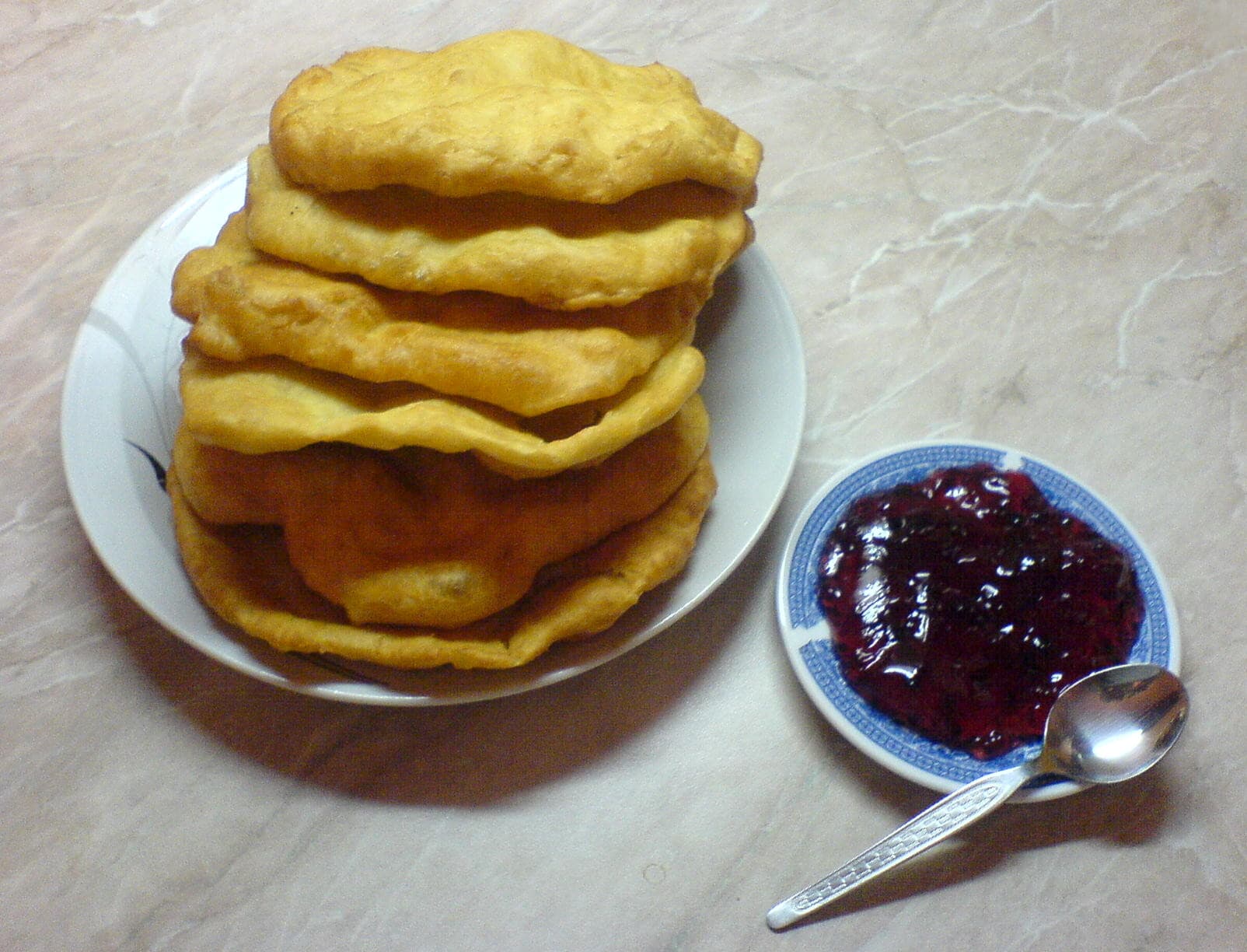 Mekitsa — a bulgarian breakfast dish from Bulgaria — featuring yogurt-based dough, deep-fried, pillow-soft