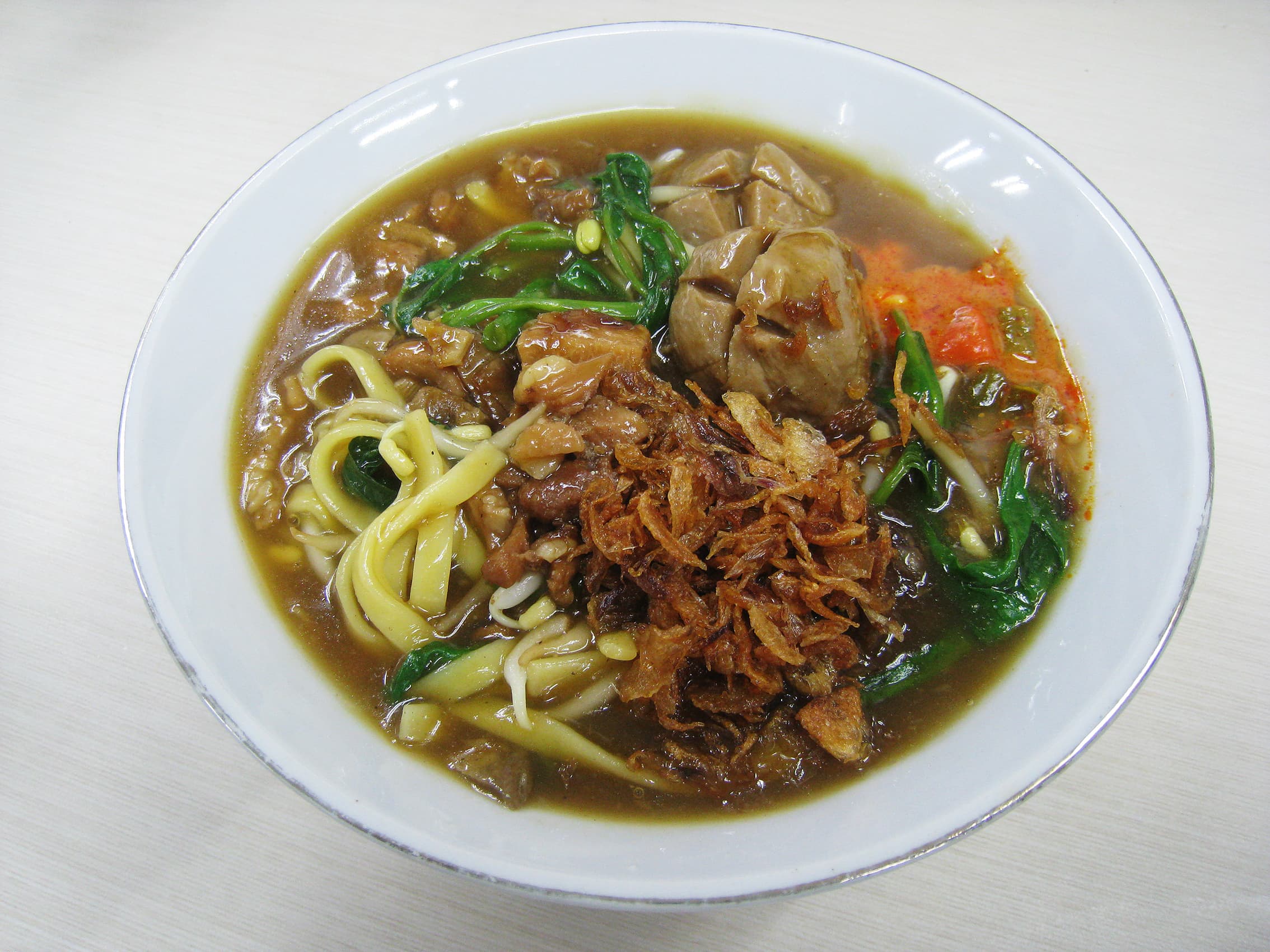 Mie kangkung — a indonesian main course dish from Indonesia — featuring thick tapioca broth, water spinach base, Betawi Jakarta specialty