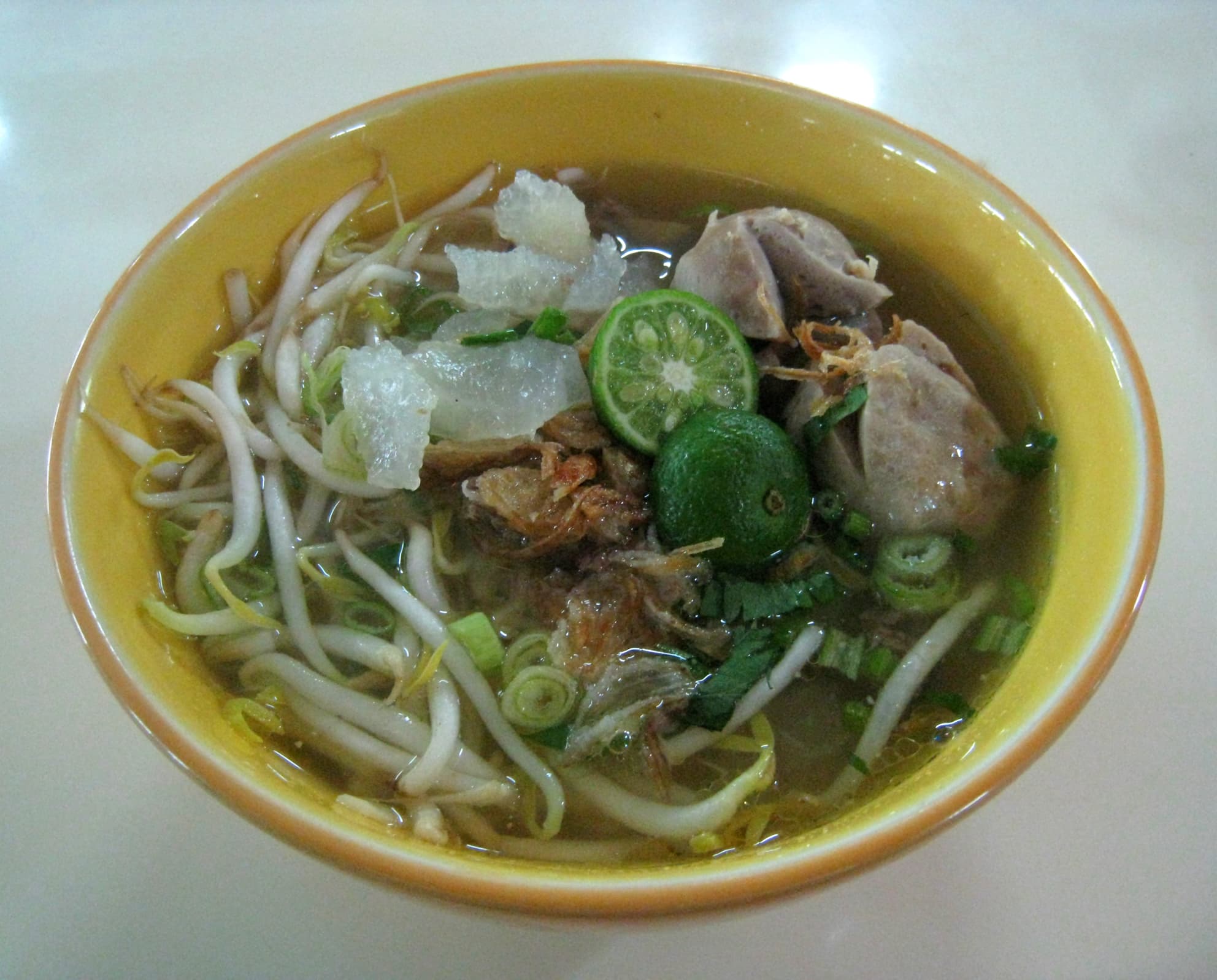 Mie kocok — a indonesian main course dish from Indonesia — featuring shaken-noodle technique, beef consommé broth, kikil & bakso