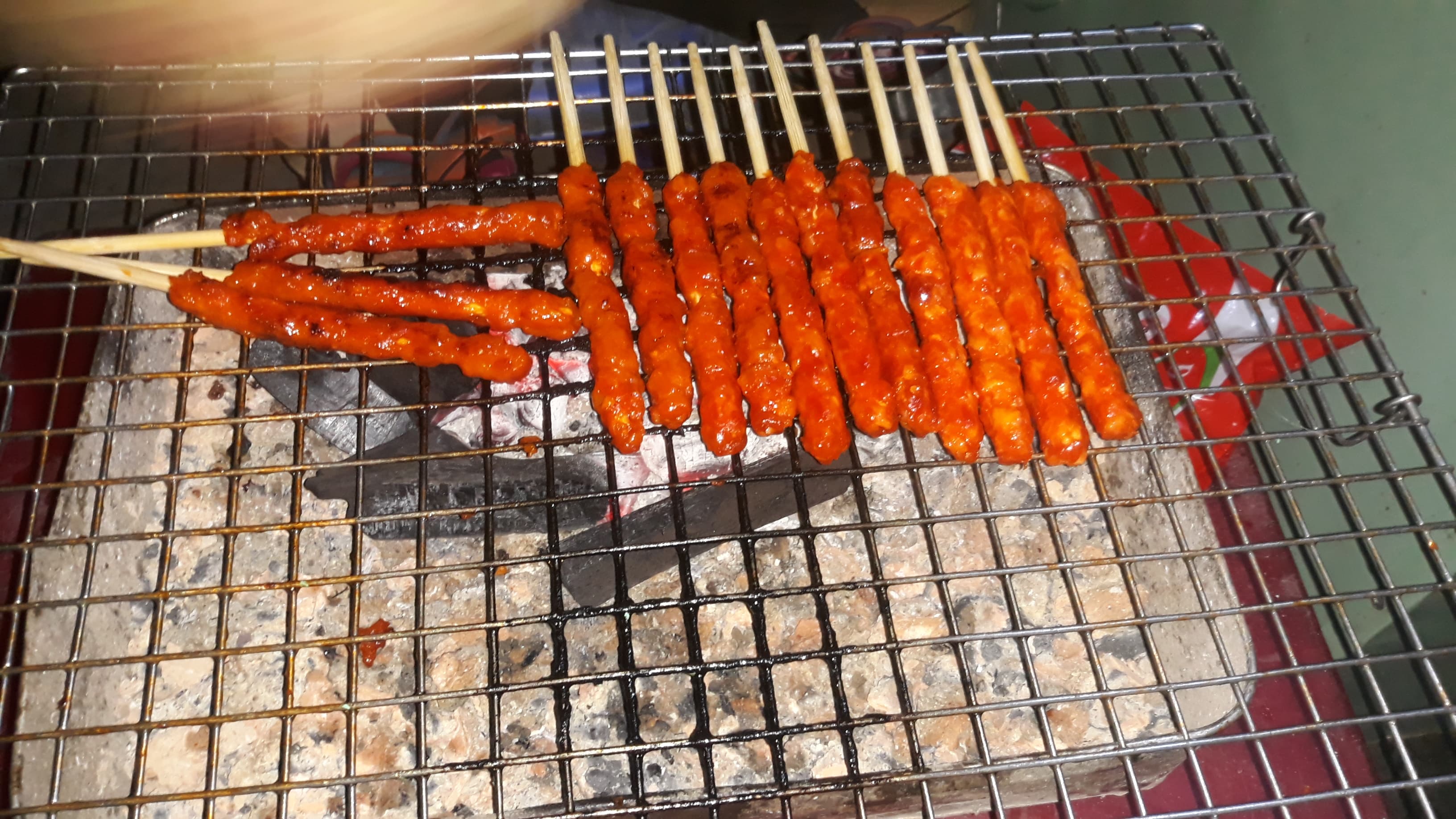 Nem nướng — a vietnamese snack dish from Vietnam — featuring grilled, pork-based, rustic