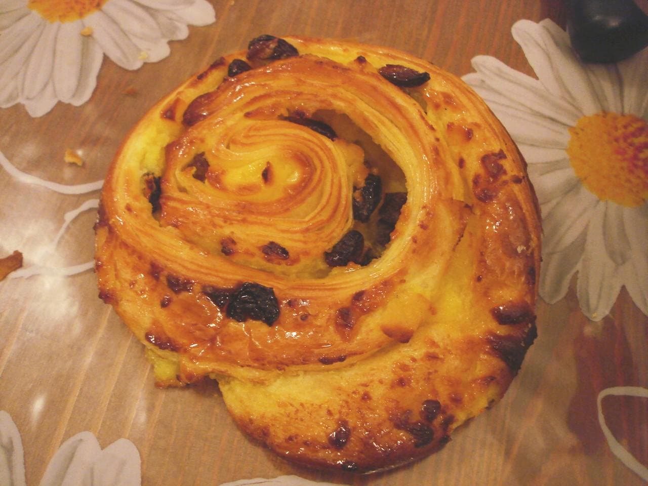 Pain aux raisins — a french breakfast dish from France — featuring laminated dough, spiral-wound, crème pâtissière filling