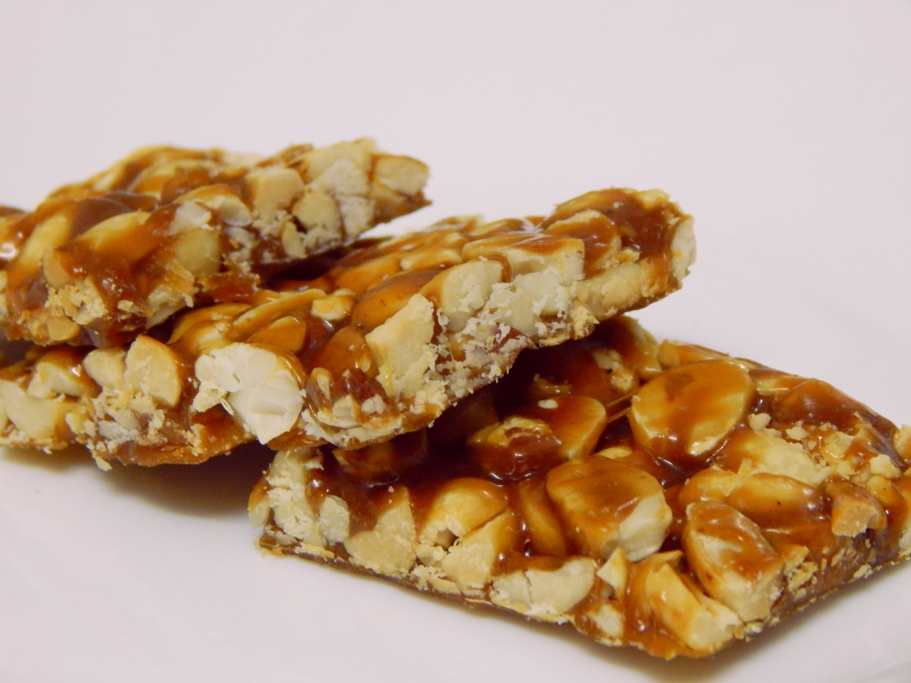 Chikki — a indian main course dish from India — featuring nut brittle, jaggery-set, shattering texture