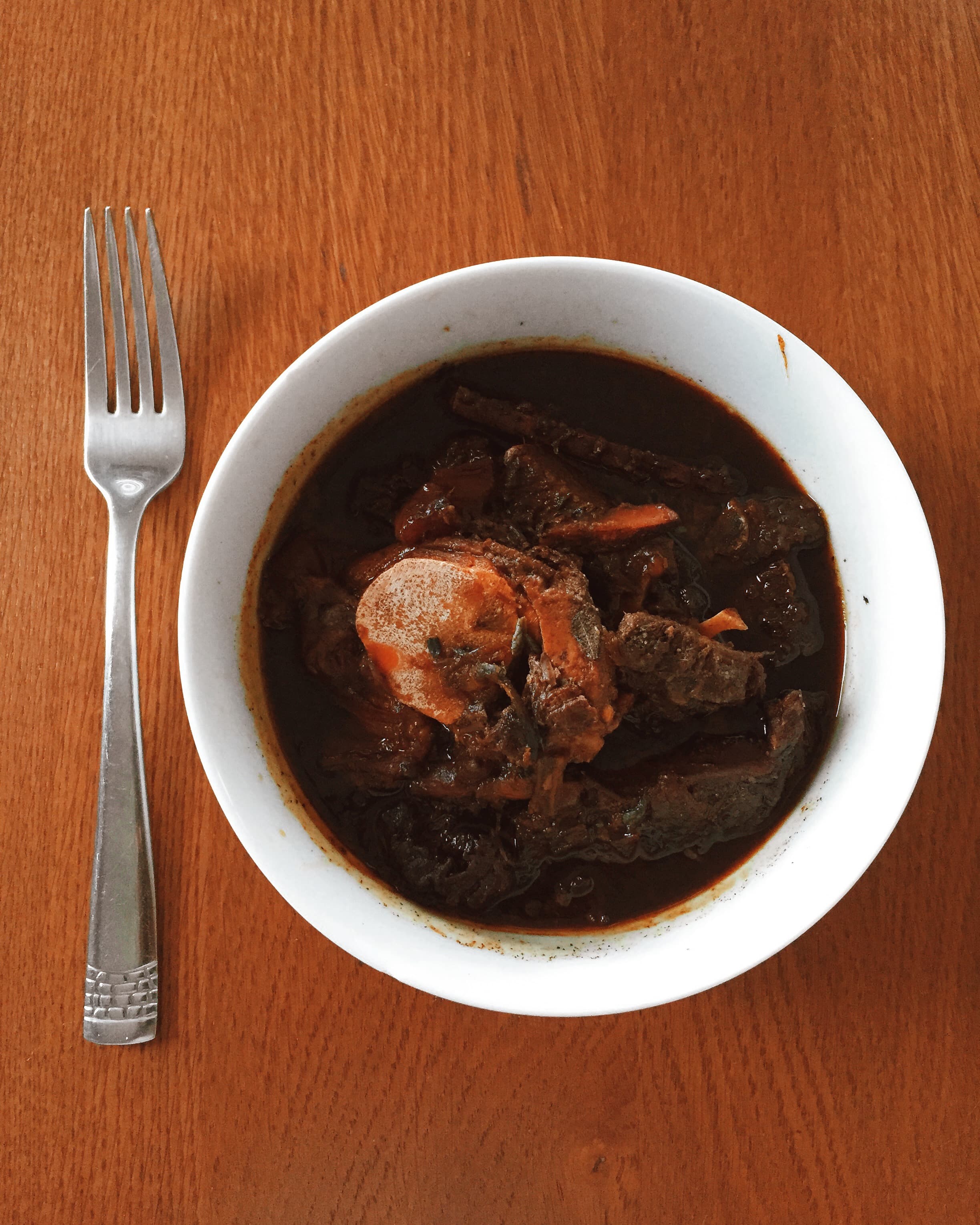 Guyanese pepperpot — a guyana cuisine main course dish from Guyana — featuring slow-cooked stew, cassareep-preserved, wiri wiri heat
