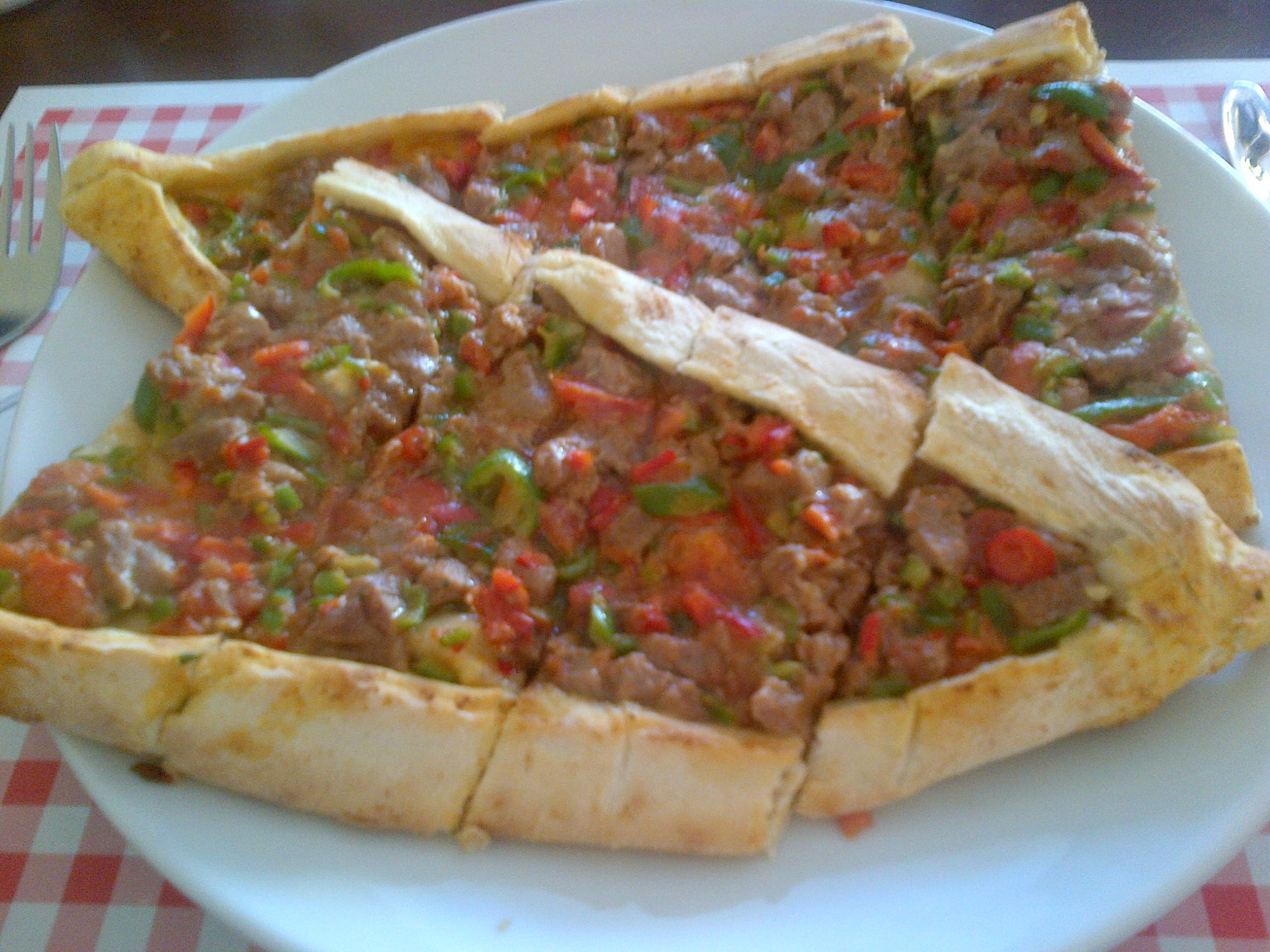 Tahinli pide — a turkish main course dish from Turkey — featuring boat-shaped pastry, sesame-forward, Ottoman origins