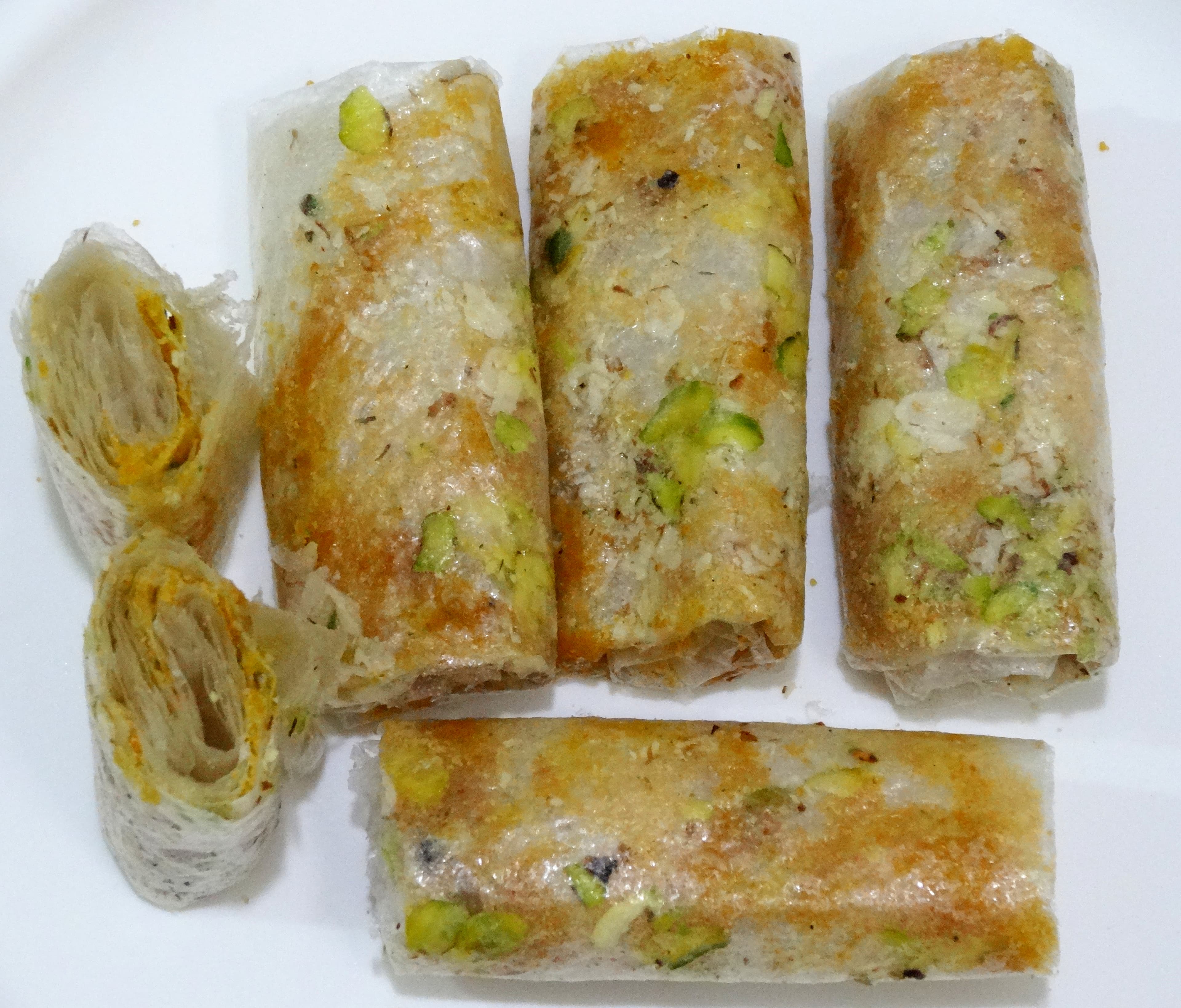 Pootharekulu — a indian main course dish from India — featuring rice paper wrapper, hand-wrapped, festival sweet