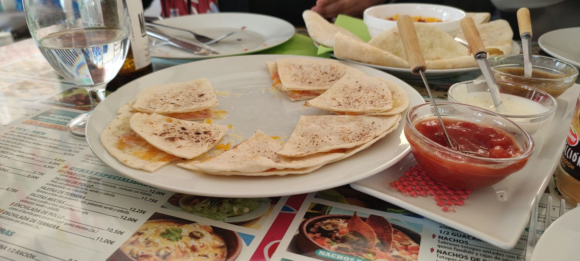 Quesadilla — a mexican main course dish from Mexico — featuring griddle-cooked, cheese-filled, folded tortilla