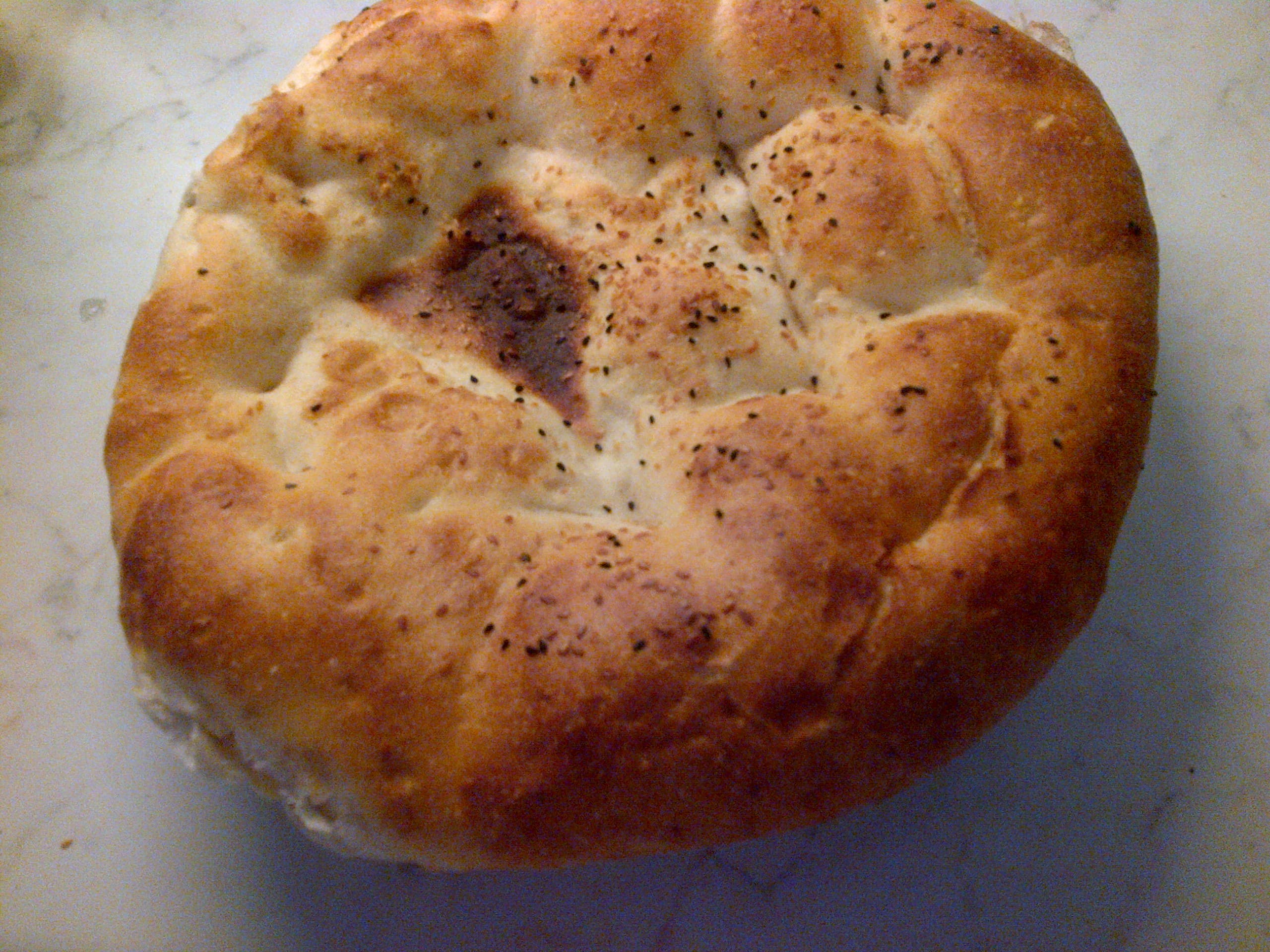 Ramazan pidesi — a turkish main course dish from Turkey — featuring soft-leavened, flat round form, weave-patterned crust