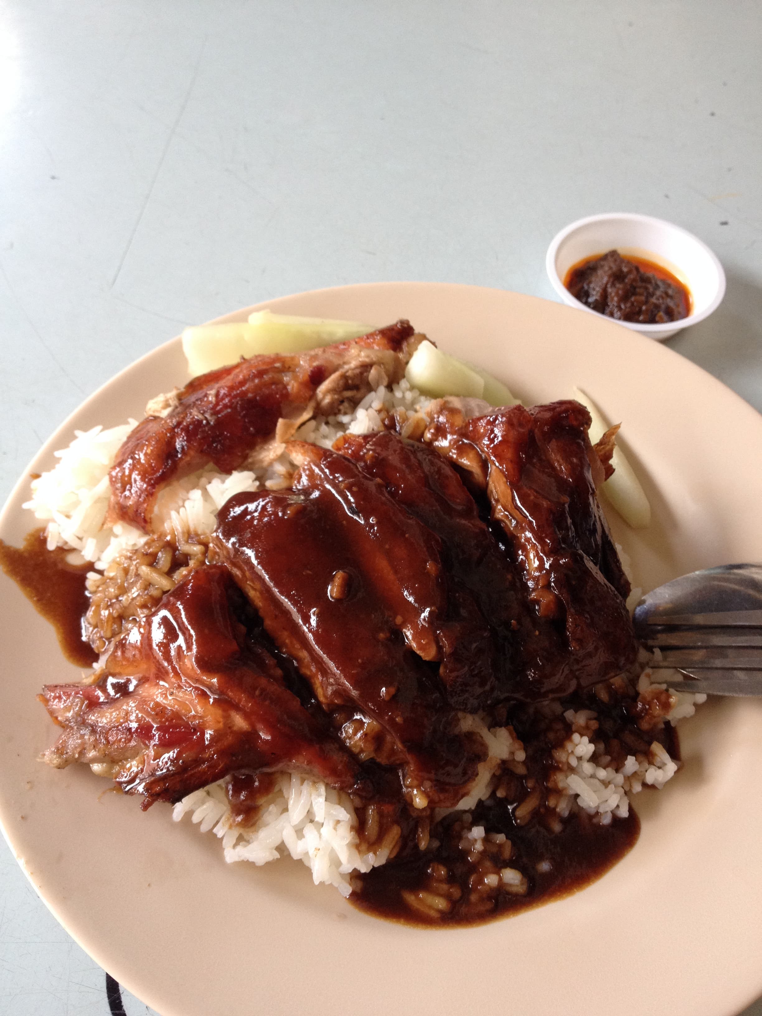 Duck rice — a singaporean main course dish from Singapore — featuring braised and roasted, sauce-soaked, deboned refinement