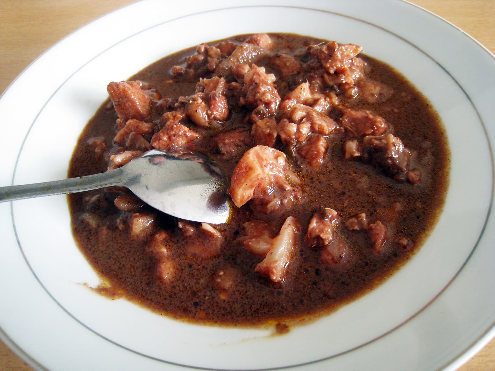 Saksang — a indonesian main course dish from Indonesia — featuring blood-based stew, coconut milk broth, Batak ceremonial