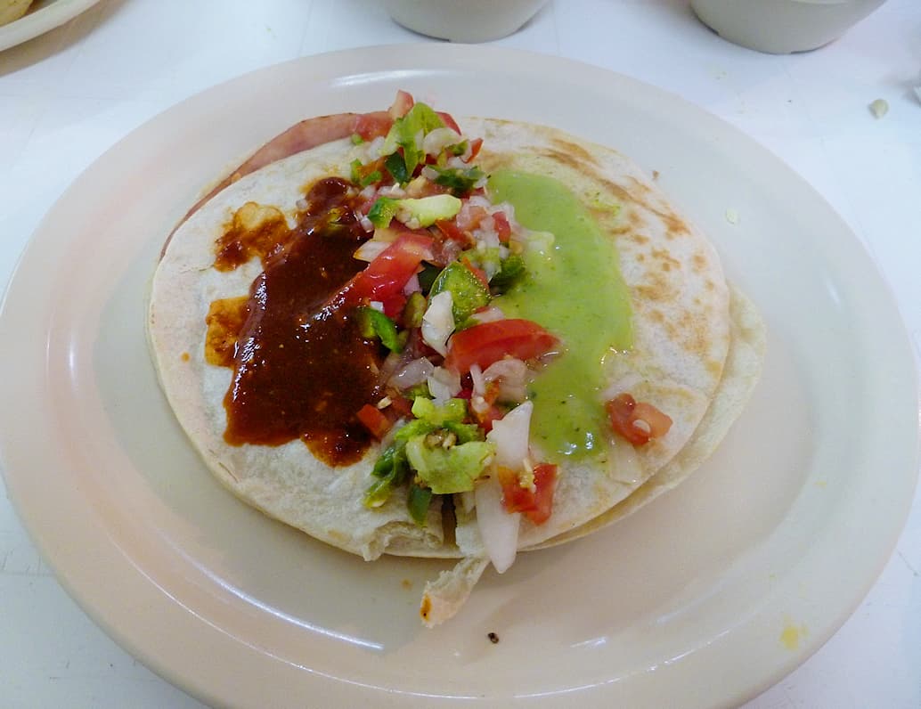 Sincronizada — a mexican main course dish from Mexico — featuring griddled, flour tortilla sandwich, ham-forward