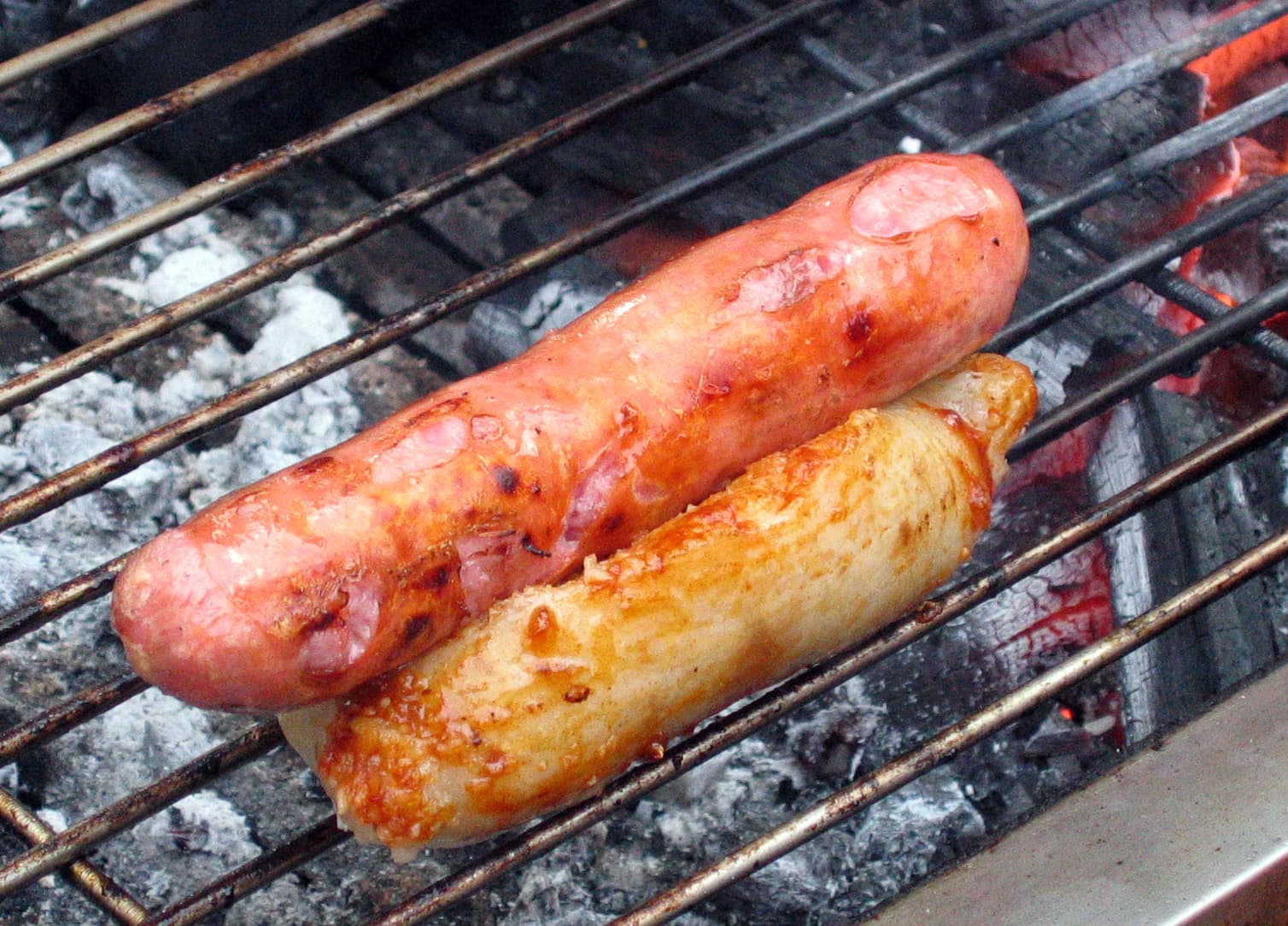 Small sausage in large sausage — a taiwanese snack dish from Taiwan — featuring chargrilled, sticky rice encased, pork-forward