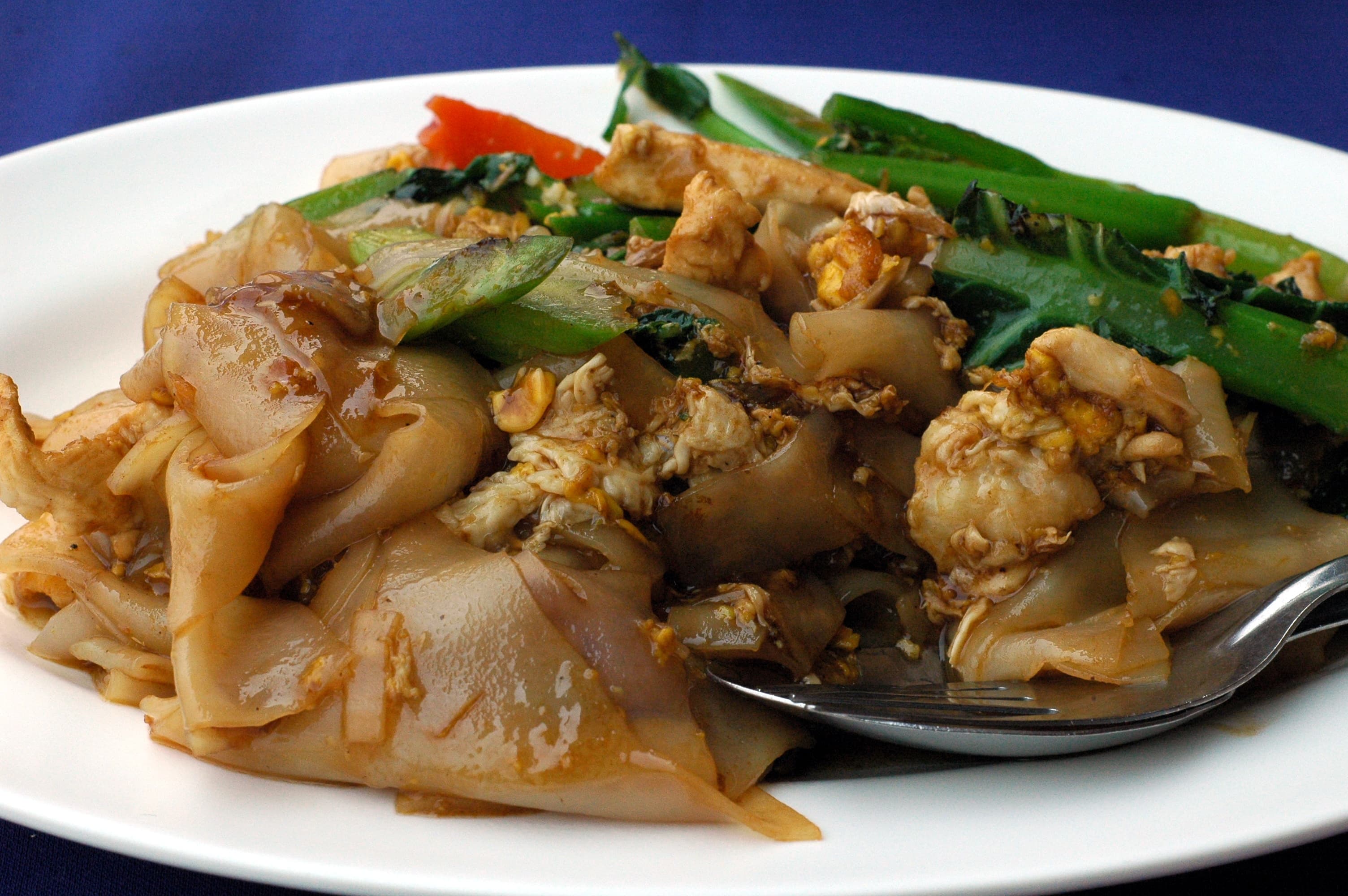 Pad See Ew — a thai main course dish from Bangkok, Thailand — featuring wok hai char, wide rice noodles, dark sweet soy