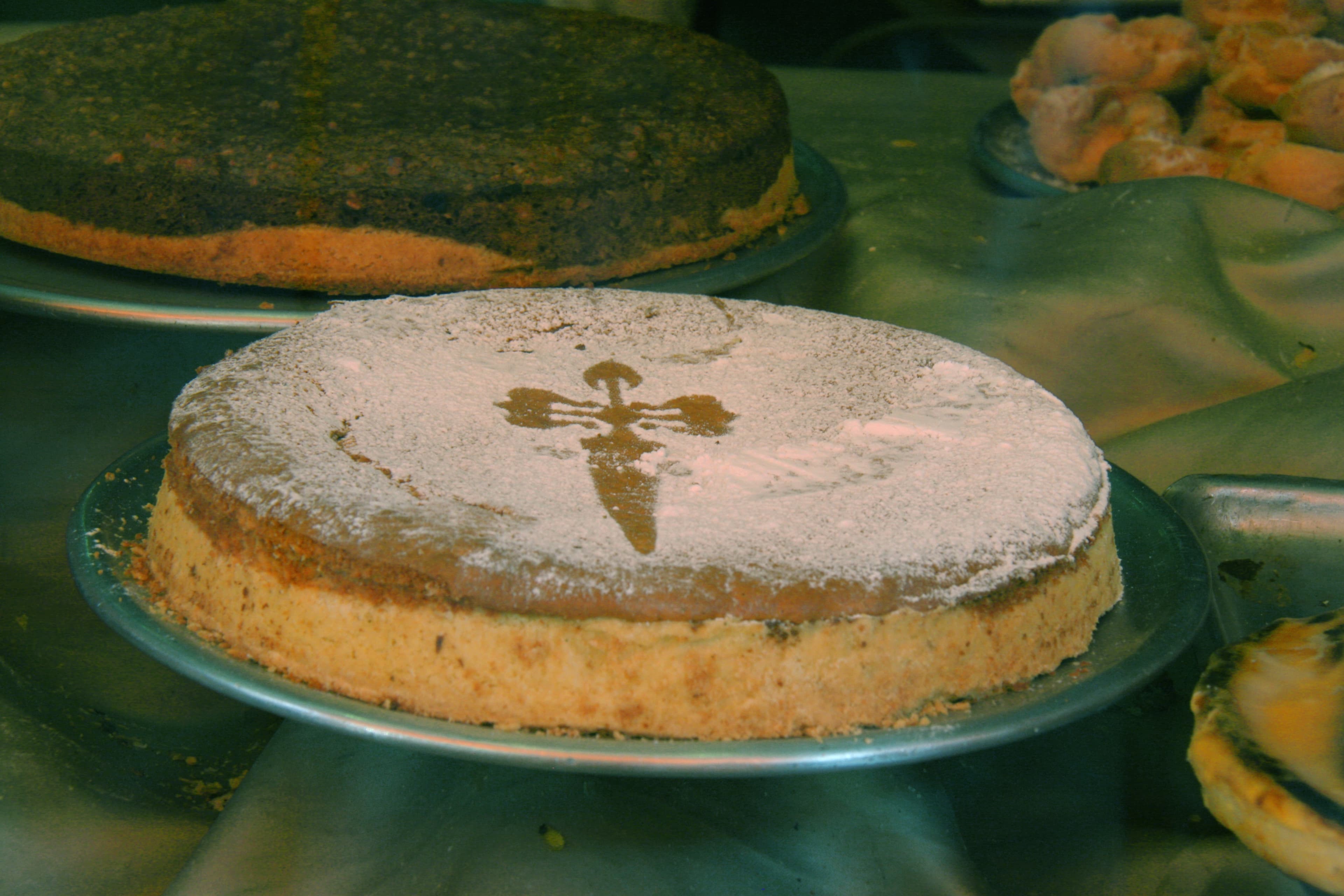 Tarta de Santiago — a spanish main course dish from Spain — featuring ground almond crumb, stenciled cross topping, pastry base optional