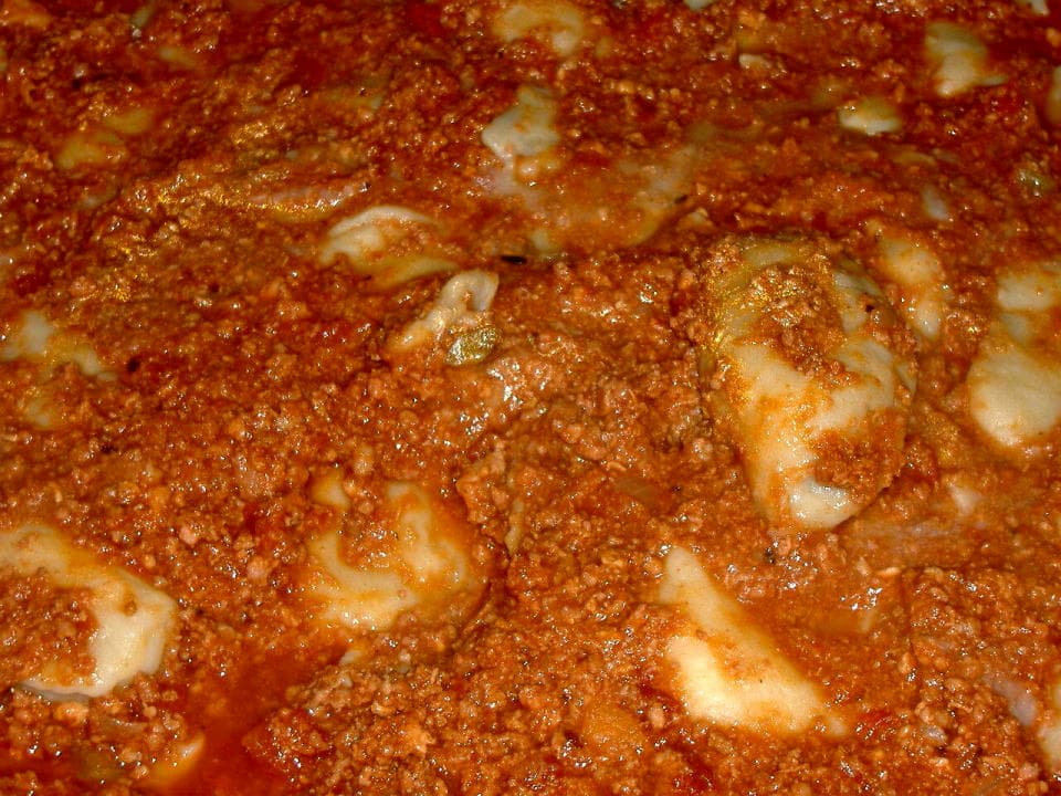Ragù — a french main course dish from France — featuring slow-cooked meat sauce, regional Italian variations, pasta-bound