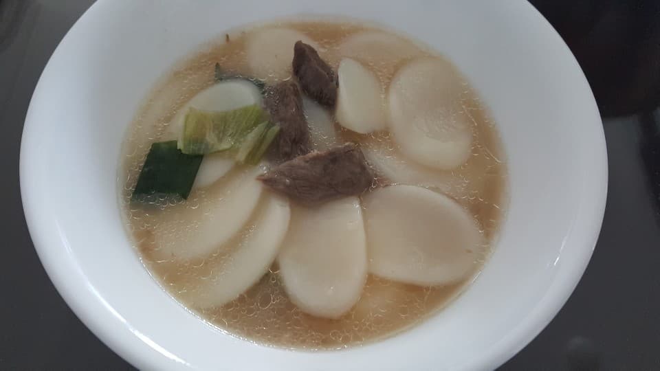 Tteokguk — a korea cuisine main course dish from Korea — featuring broth-based, rice cake, sliced