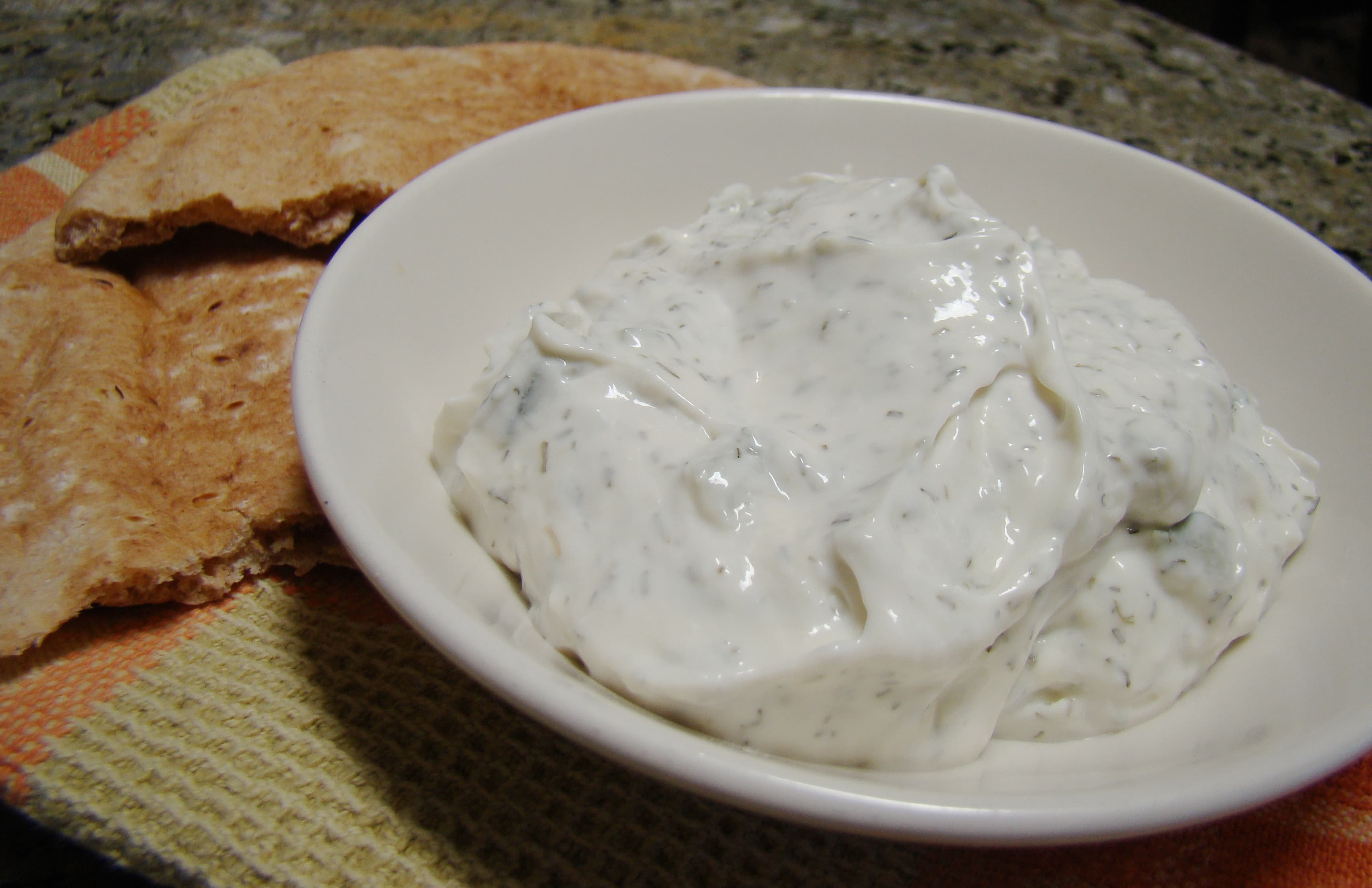 Tzatziki — a greek main course dish from Greece — featuring cold yogurt-based, herb-forward, vinegar-sharpened