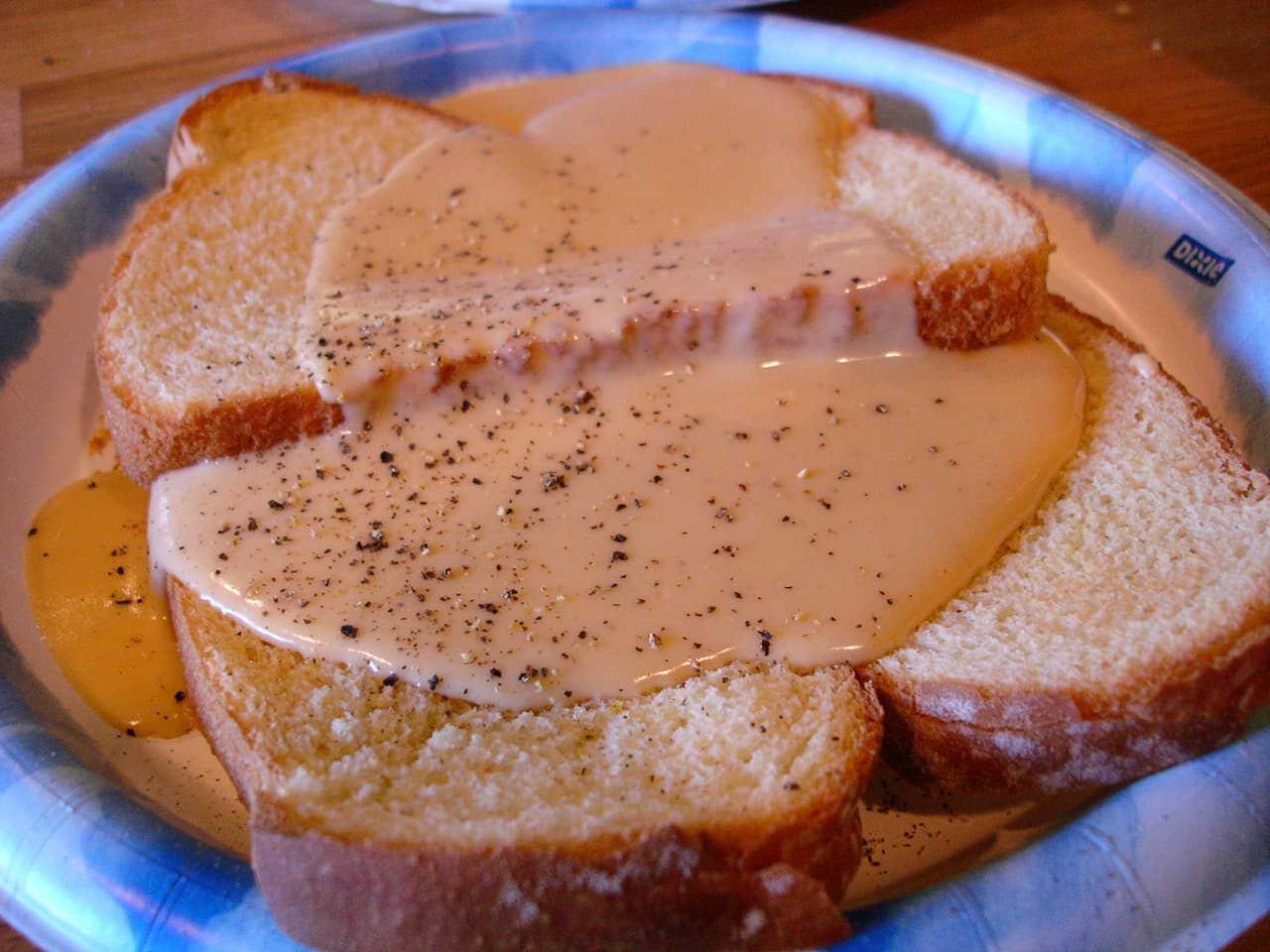 Welsh rarebit — a british main course dish from United Kingdom — featuring cheese sauce, toasted bread, ale-enriched