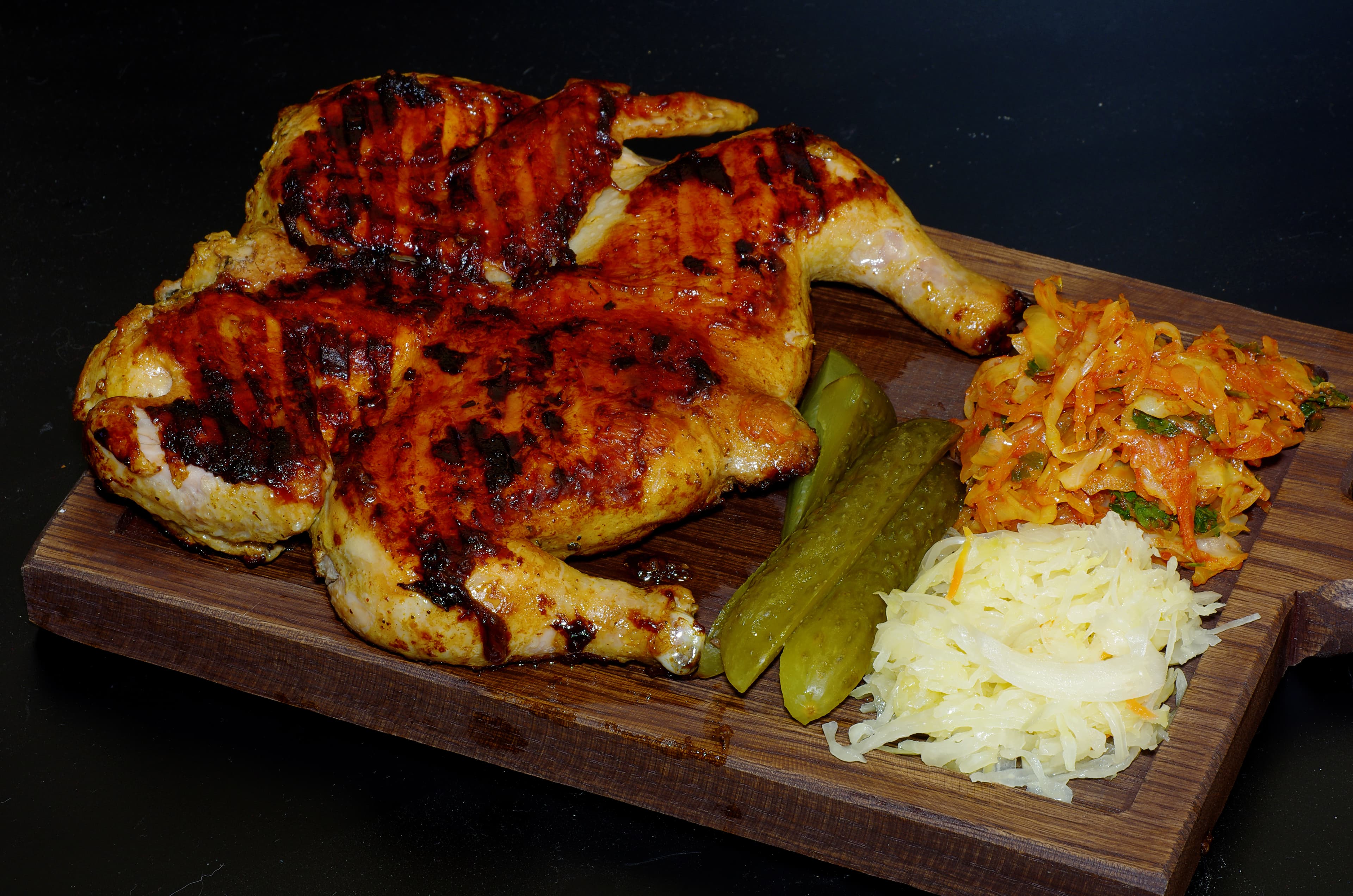Chicken tabaka — a georgian main course dish from Georgia — featuring weight-pressed, pan-flattened, crisp-skinned