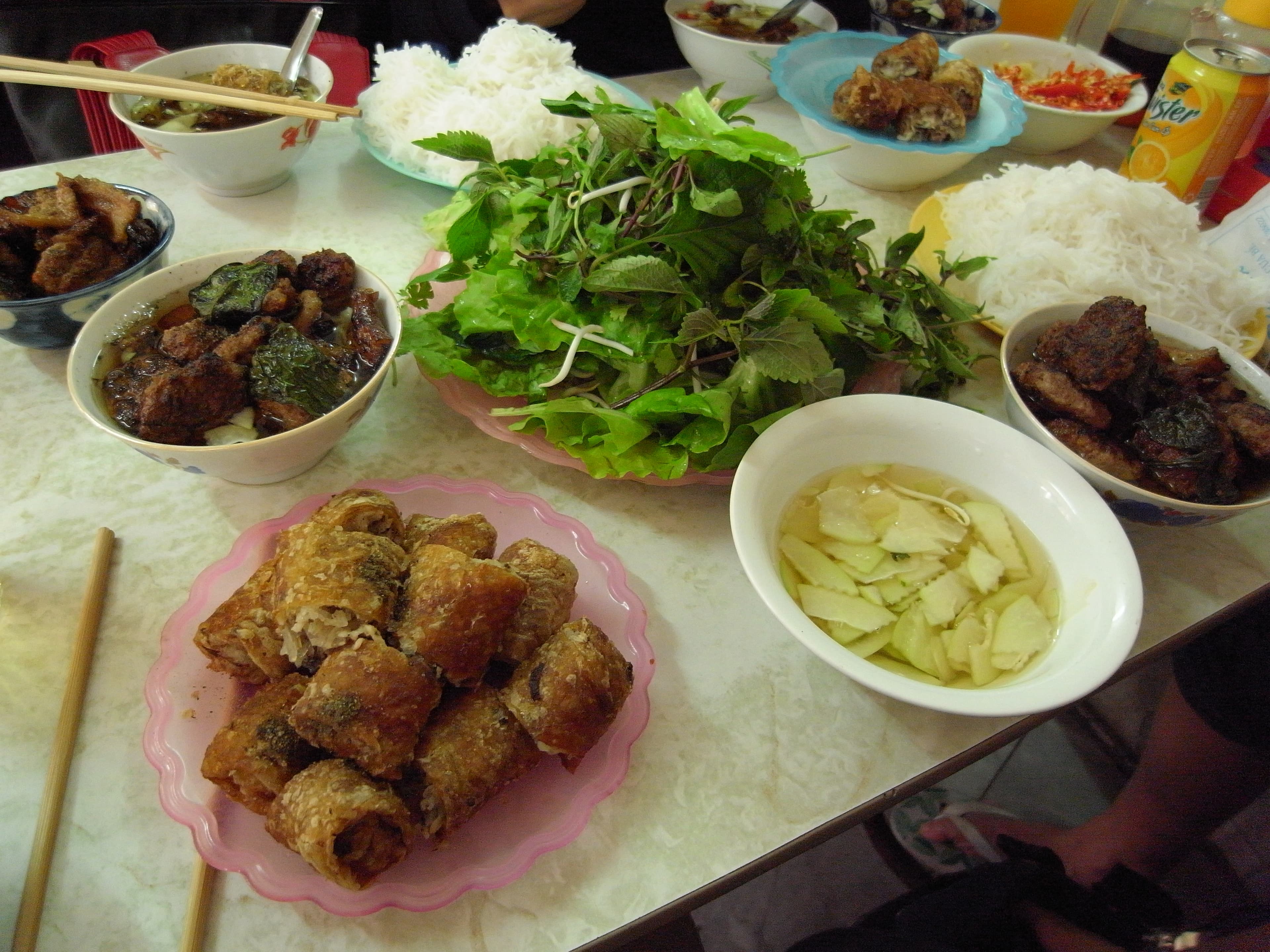 Bun cha — a vietnamese main course dish from Vietnam — featuring grilled fatty pork, rice noodles, herb-forward
