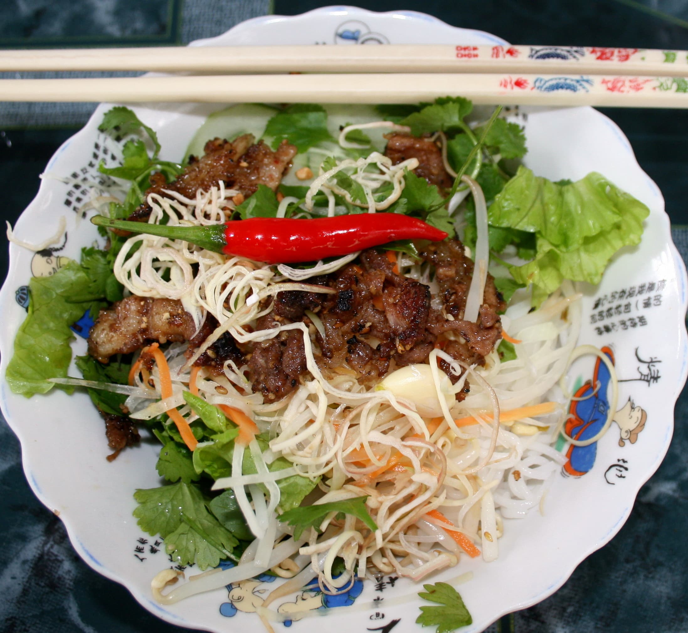 Bún thịt nướng — a vietnamese main course dish from Vietnam — featuring cold noodle base, grilled pork, herb-forward