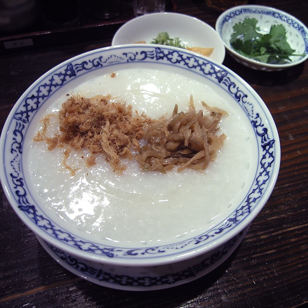Congee — a asia cuisine breakfast dish from Asia — featuring slow-boiled rice porridge, variable thickness, adaptable base