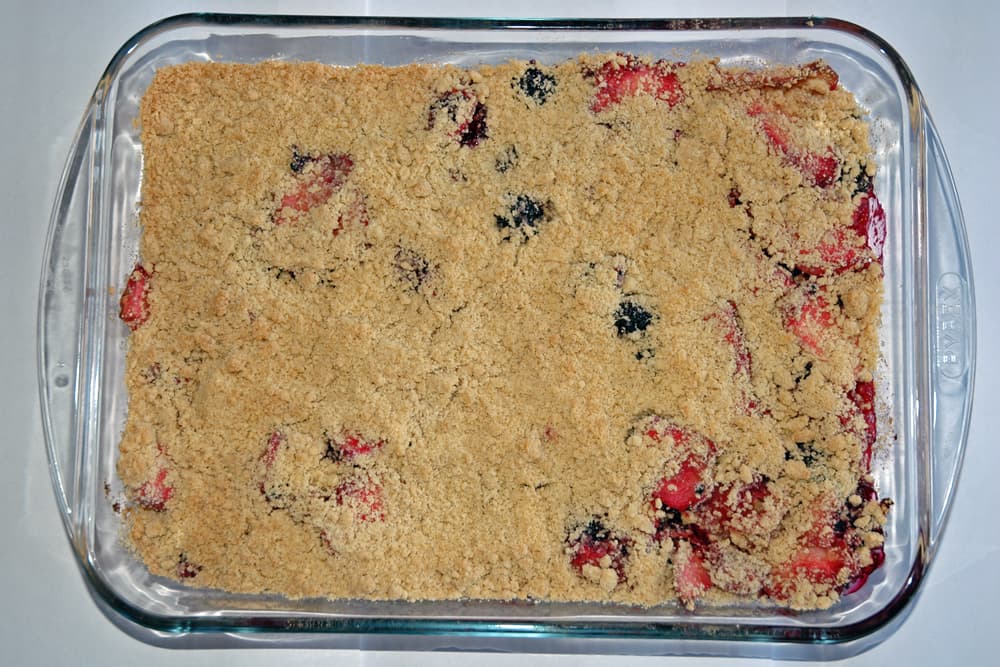 Crumble — a british dessert dish from United Kingdom — featuring streusel topping, baked fruit, Commonwealth classic