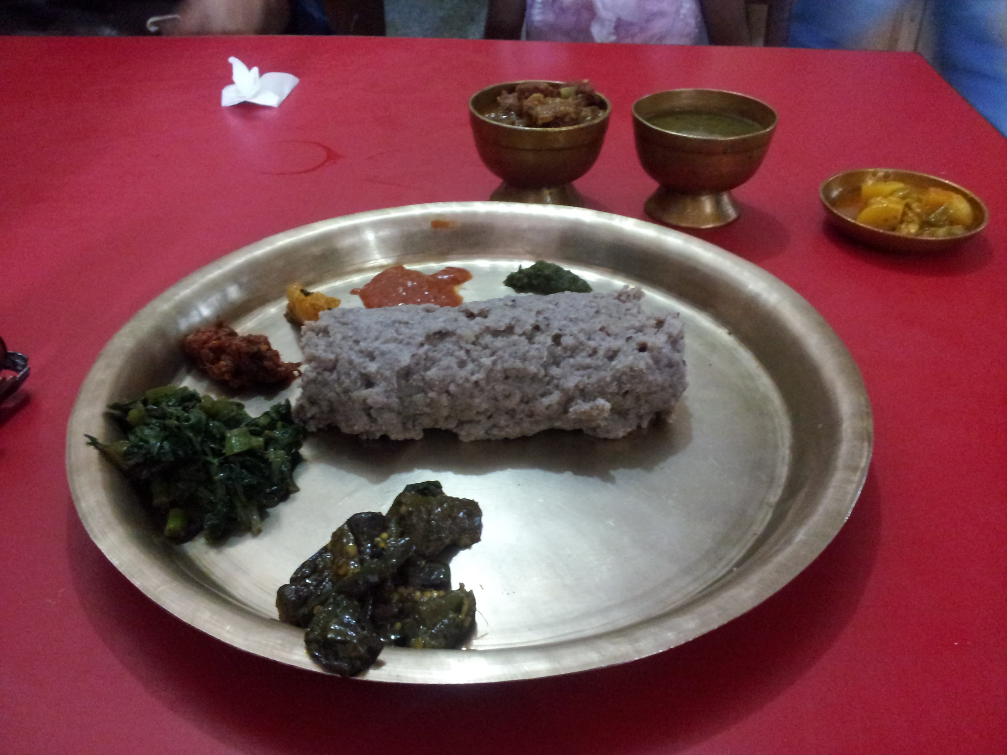 Dhindo — a nepali main course dish from Nepal — featuring stirred porridge, mountainous Nepal, flour-based