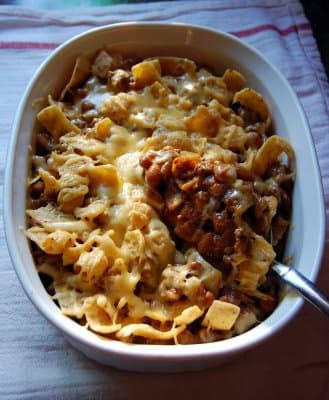 Frito pie — a american main course dish from United States — featuring one-dish casual, chip-based, chili-forward