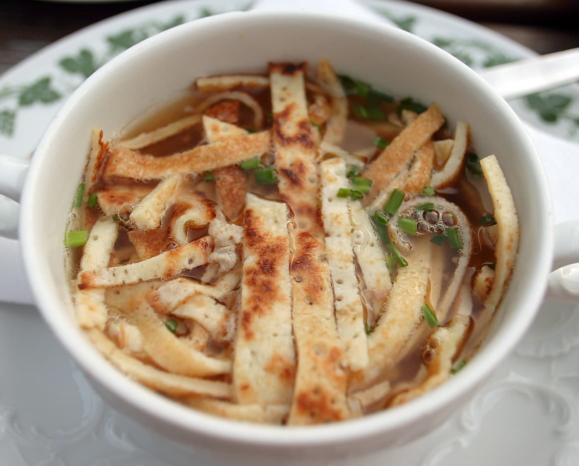Flädle — a german main course dish from Germany — featuring crepe-style ribbons, rolled and sliced, savory pancakes