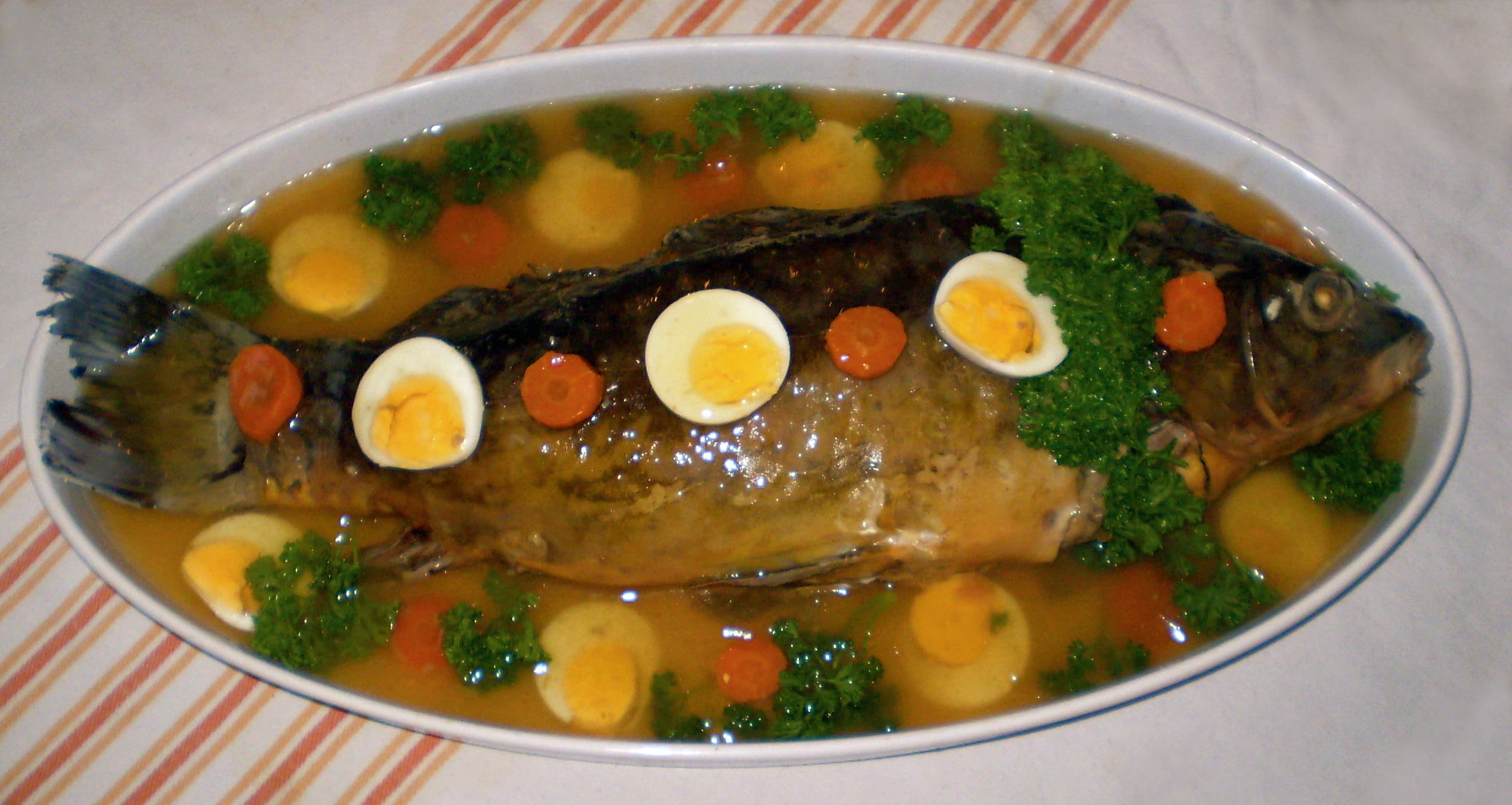 Gefilte fish — a central europe cuisine appetizer dish from Central Europe — featuring poached, ground fish forcemeat, quenelle-style patties