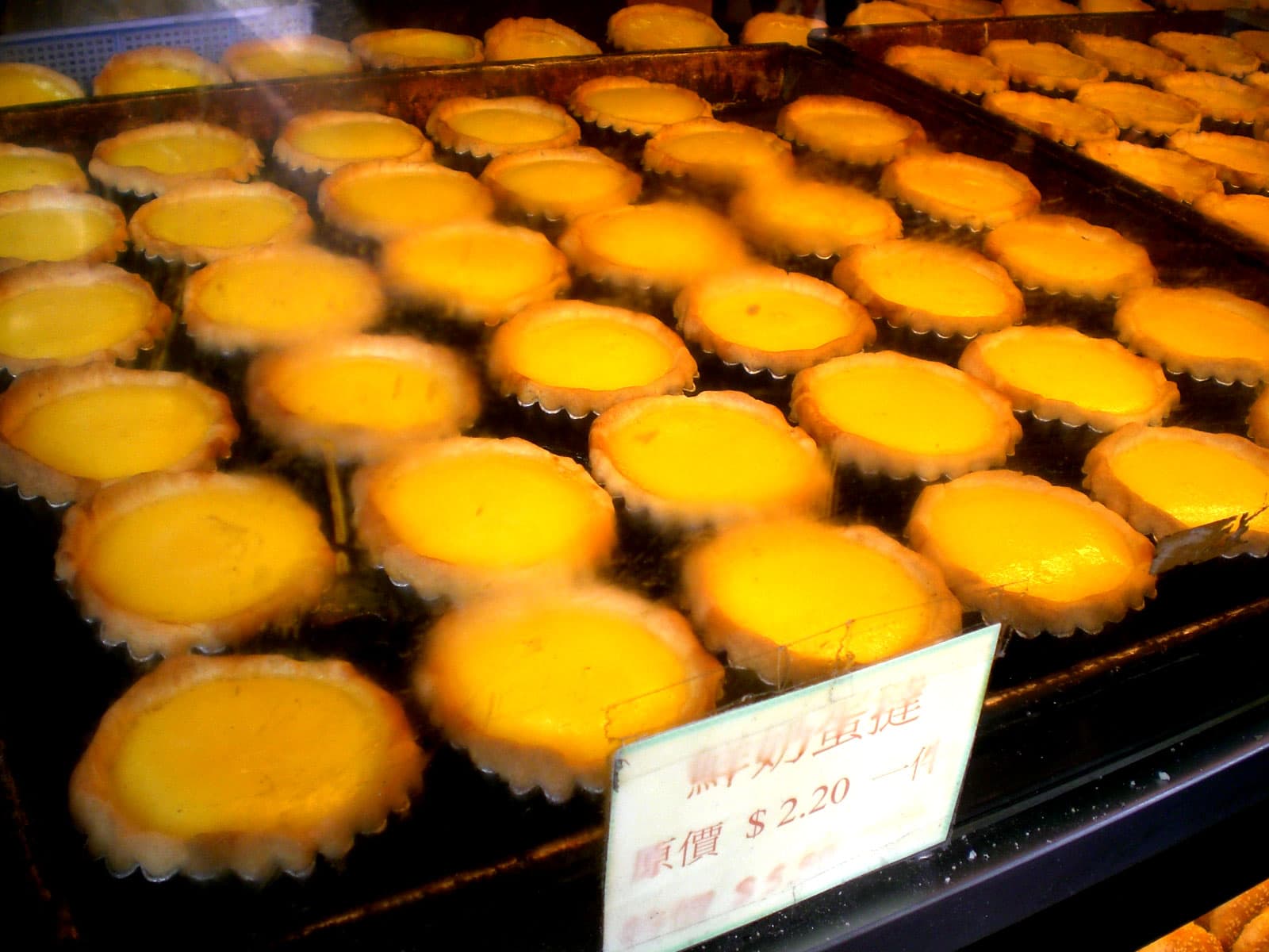 Egg tart — a british main course dish from United Kingdom — featuring custard-filled, dim sum staple, pastry shell