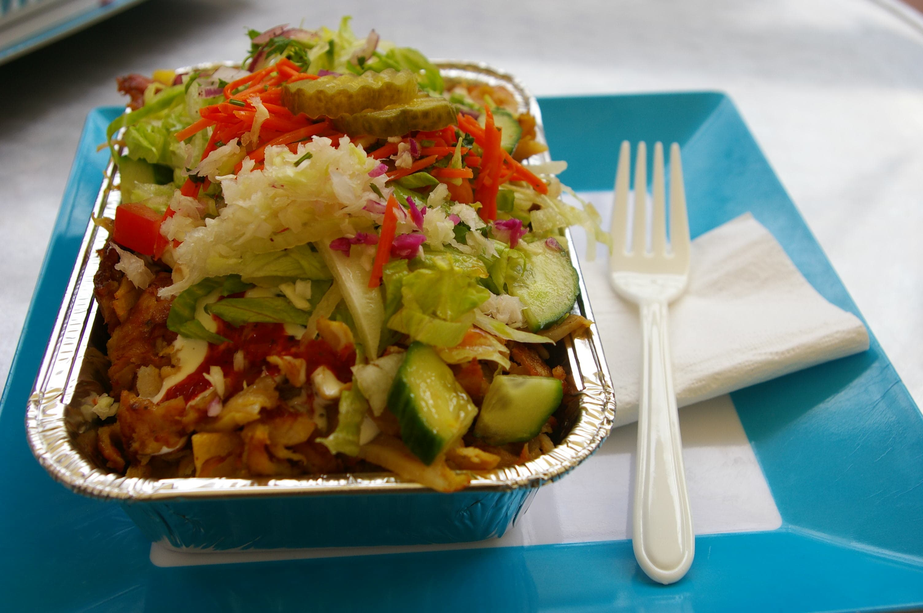 Kapsalon — a dutch main course dish from Netherlands — featuring layered, oven-melted cheese, garlic & sambal finish