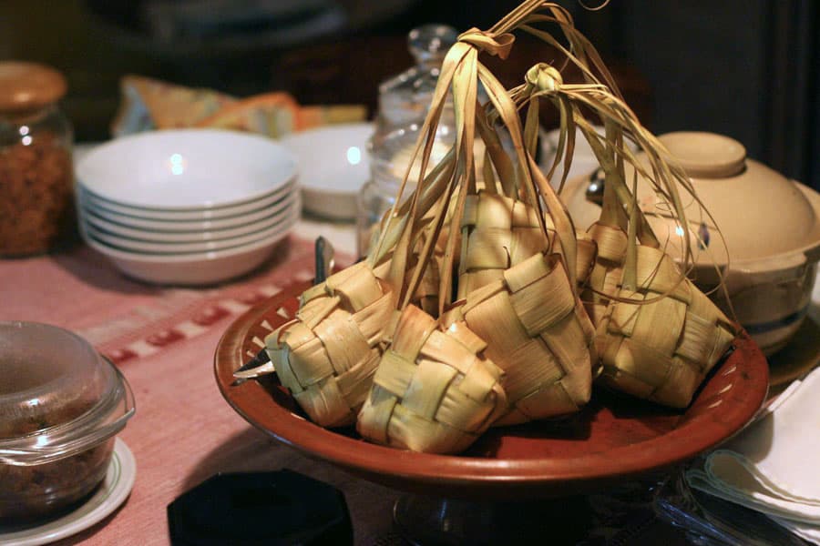 Ketupat — a malaysian main course dish from Malaysia — featuring palm-leaf wrapped, boiled rice cake, festive ceremonial